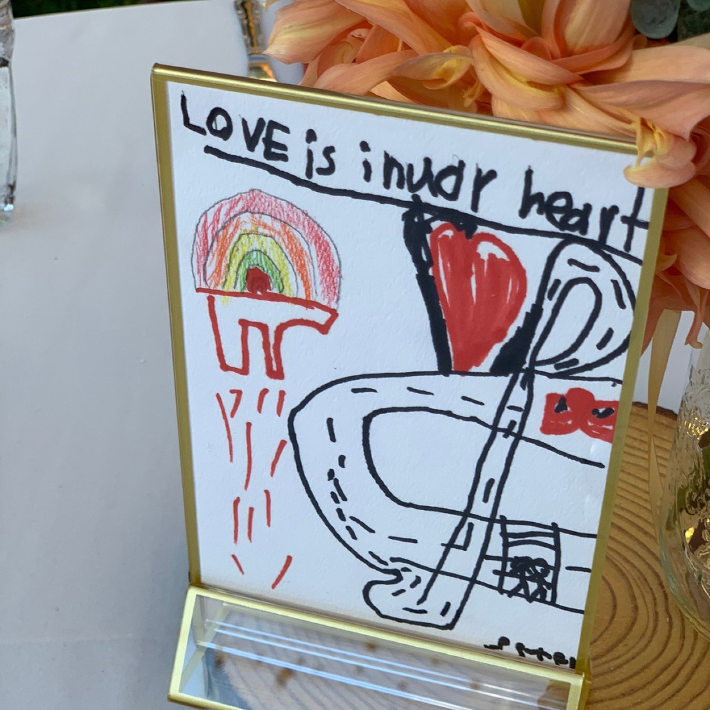 One of my all-time favorite intentional design decision - M asked her students to draw what love meant to them, and we used the drawings as the cutest table numbers. 

Each sketch was a window into the innocent and heartfelt interpretations of love, 
