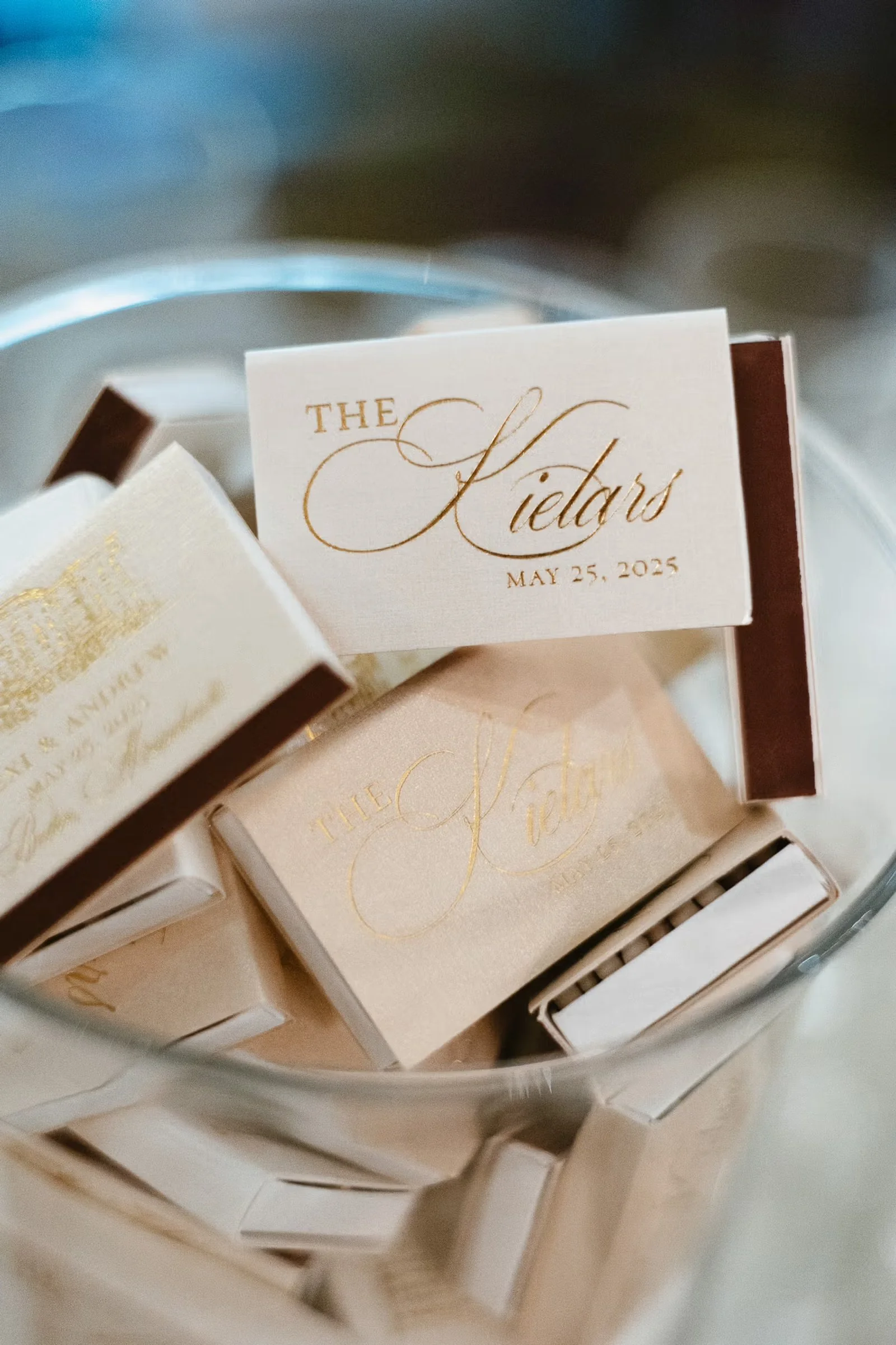 Personalized white wedding matches displayed in a glass container.
