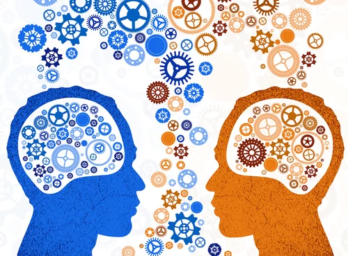 Two head silhouettes filled with gears facing each other