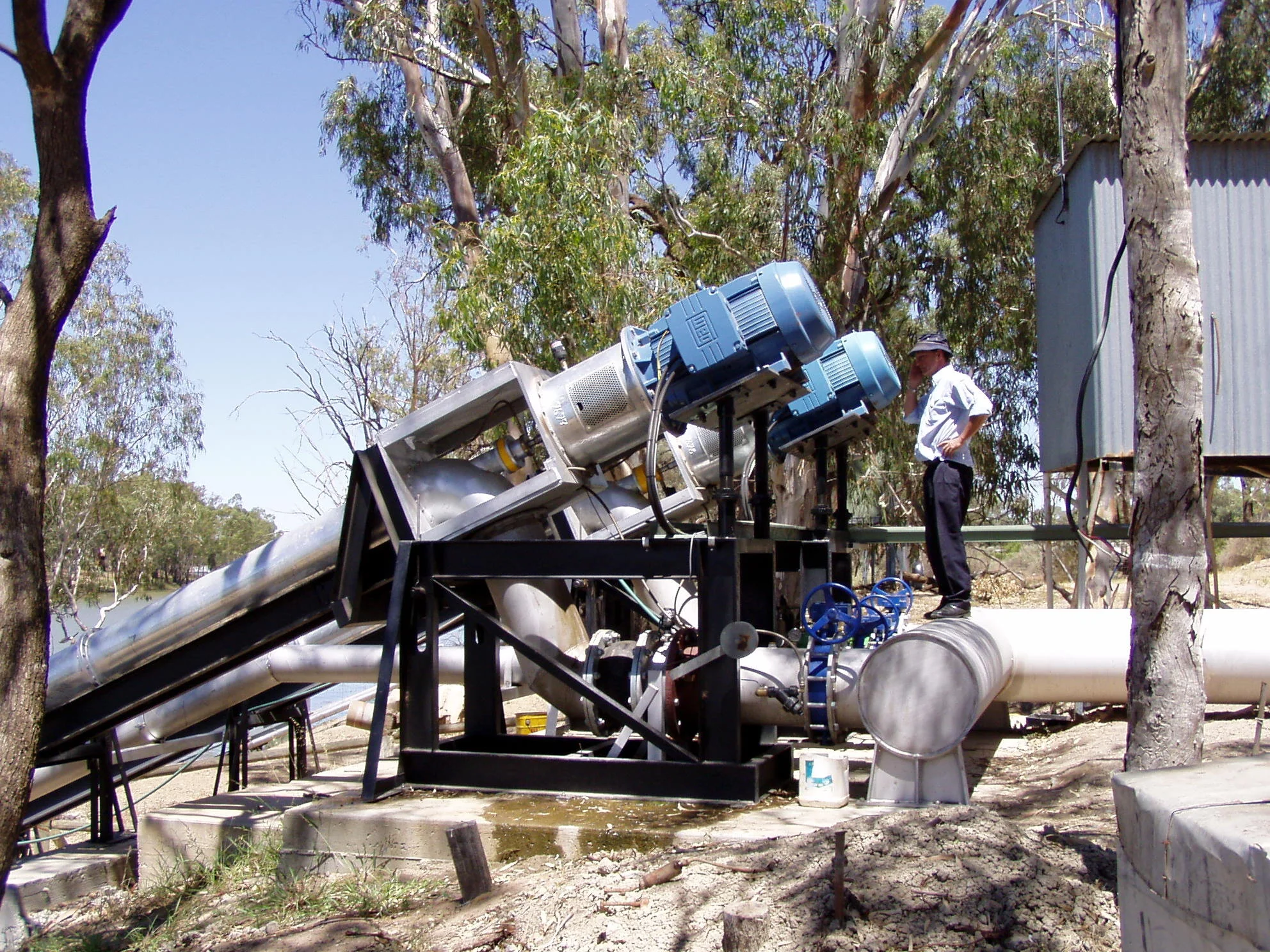 Michael inspecting 2 pumps.JPG