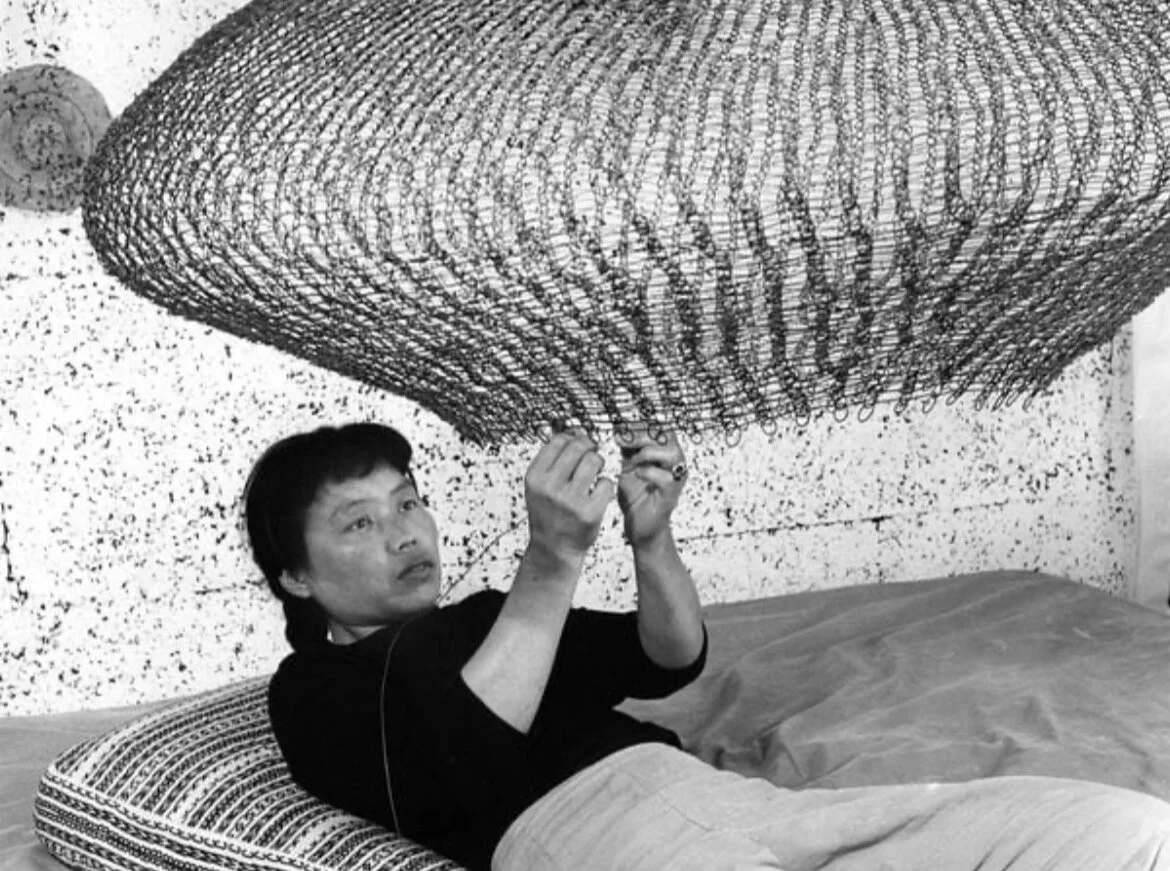 Ruth Asawa working on a looped-wire sculpture in 1957