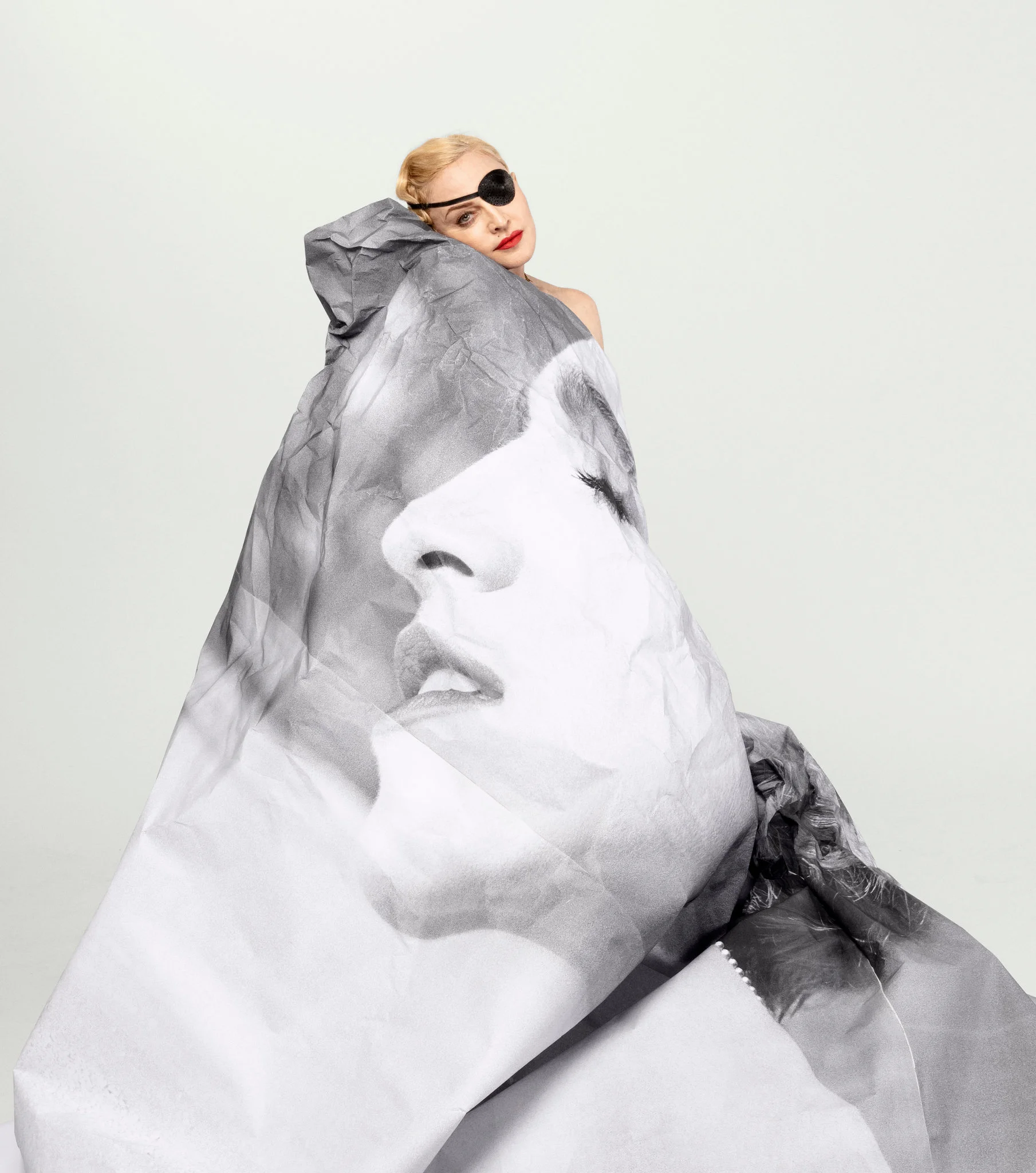 Madonna with a 1986 photograph of herself by Herb Ritts.CreditJR for The New York Times