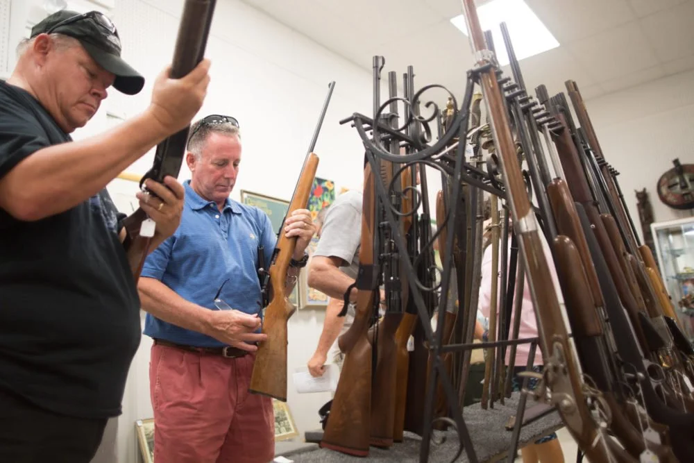 Guns and antique military paraphernalia were the featured items at the August 21 auction. During the preview time, potential buyers inspect every aspect of the lots to ensure they know what they are bidding on .