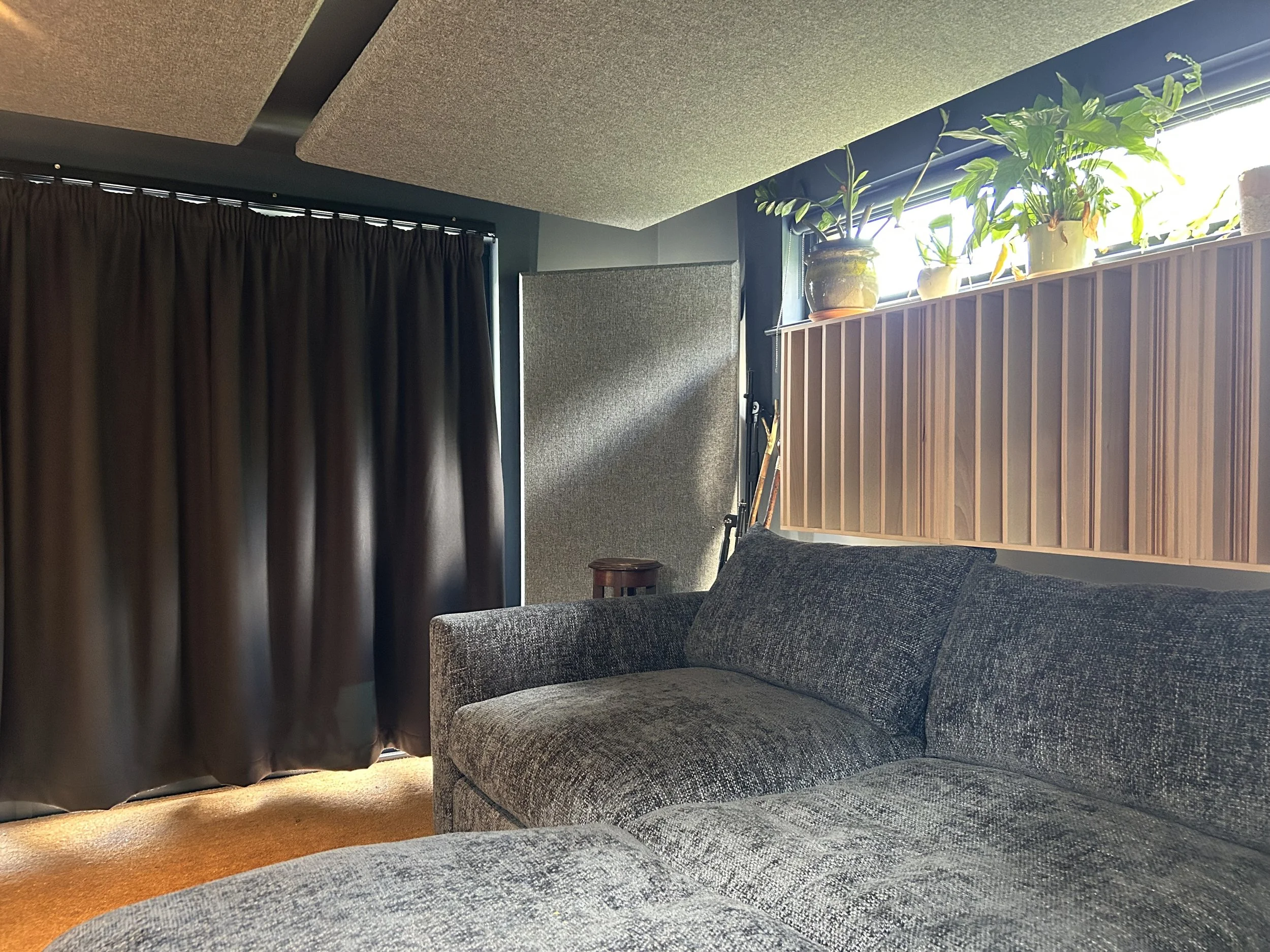 Rear of a production studio with wooden diffusors and fabric wrapped acoustic panels