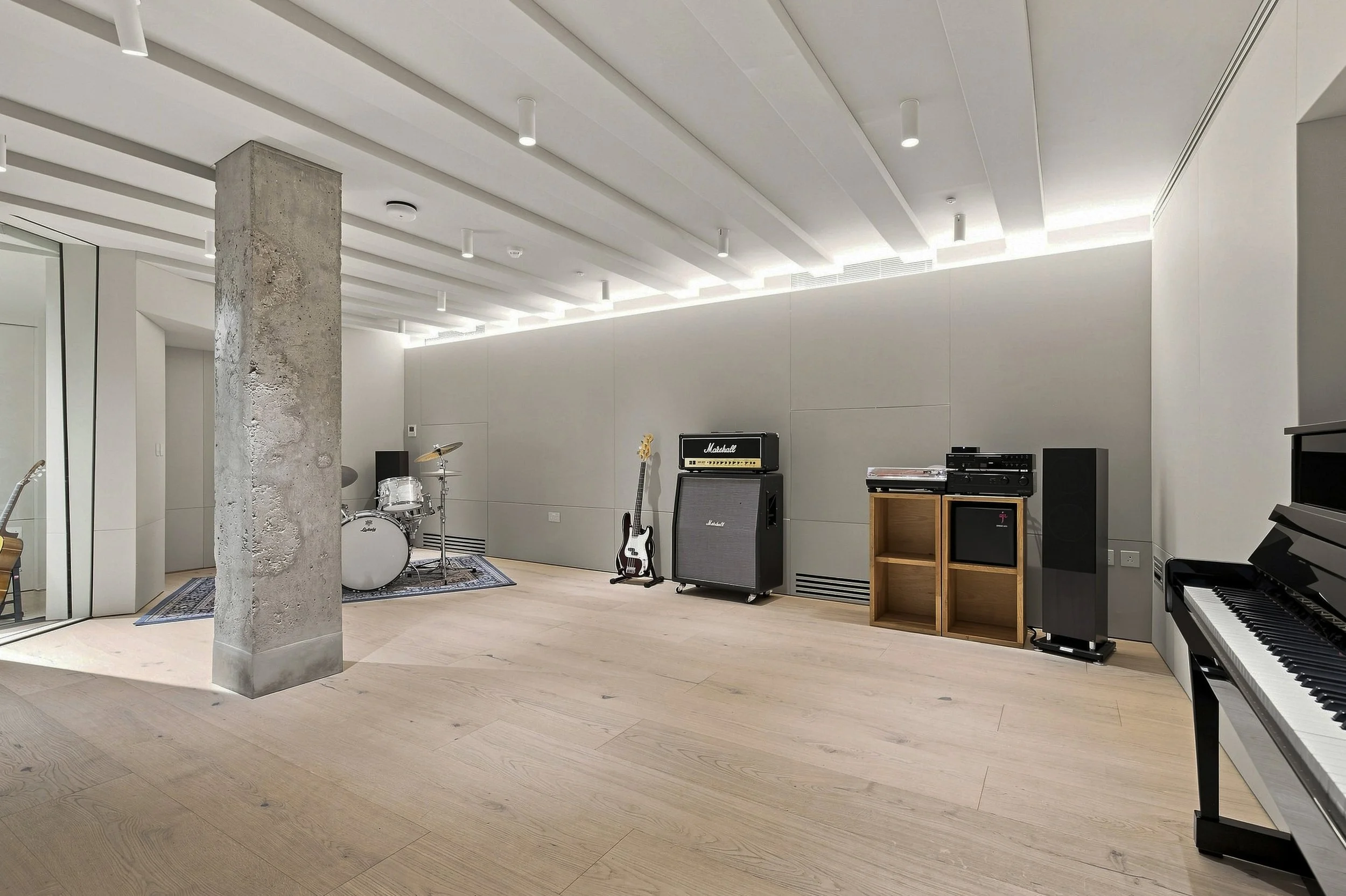  Recording studio live room with fabric wall acoustic treatment by Yellow Technology. Drums set up.  