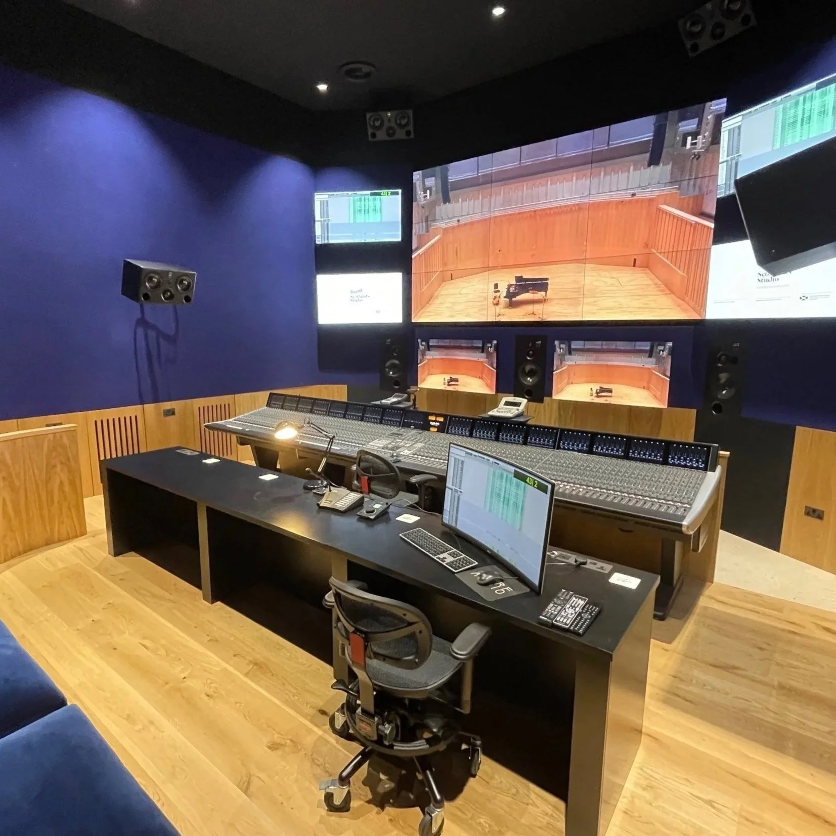Recording studio control room with Dolby Atmos monitoring and SSL mixing console