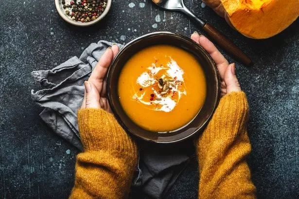 4_Female-hands-with-bowl-of-pumpkin-soup.webp
