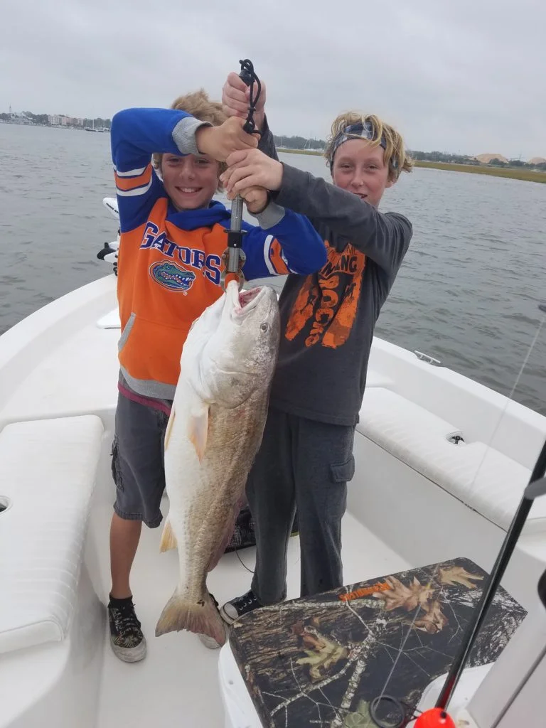 Joseph-and-David-Doyle-holding-32lbs-Red-fish-e1510580657690-768x1024.jpg