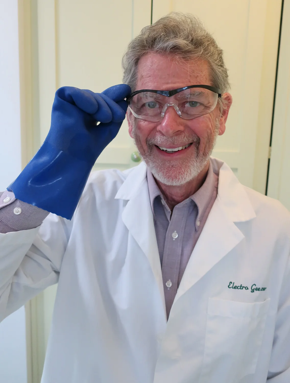 Chris Boothe smiling while wearing safety gloves, safety glasses and laboratory coat to be safe while using Multi-Etch.
