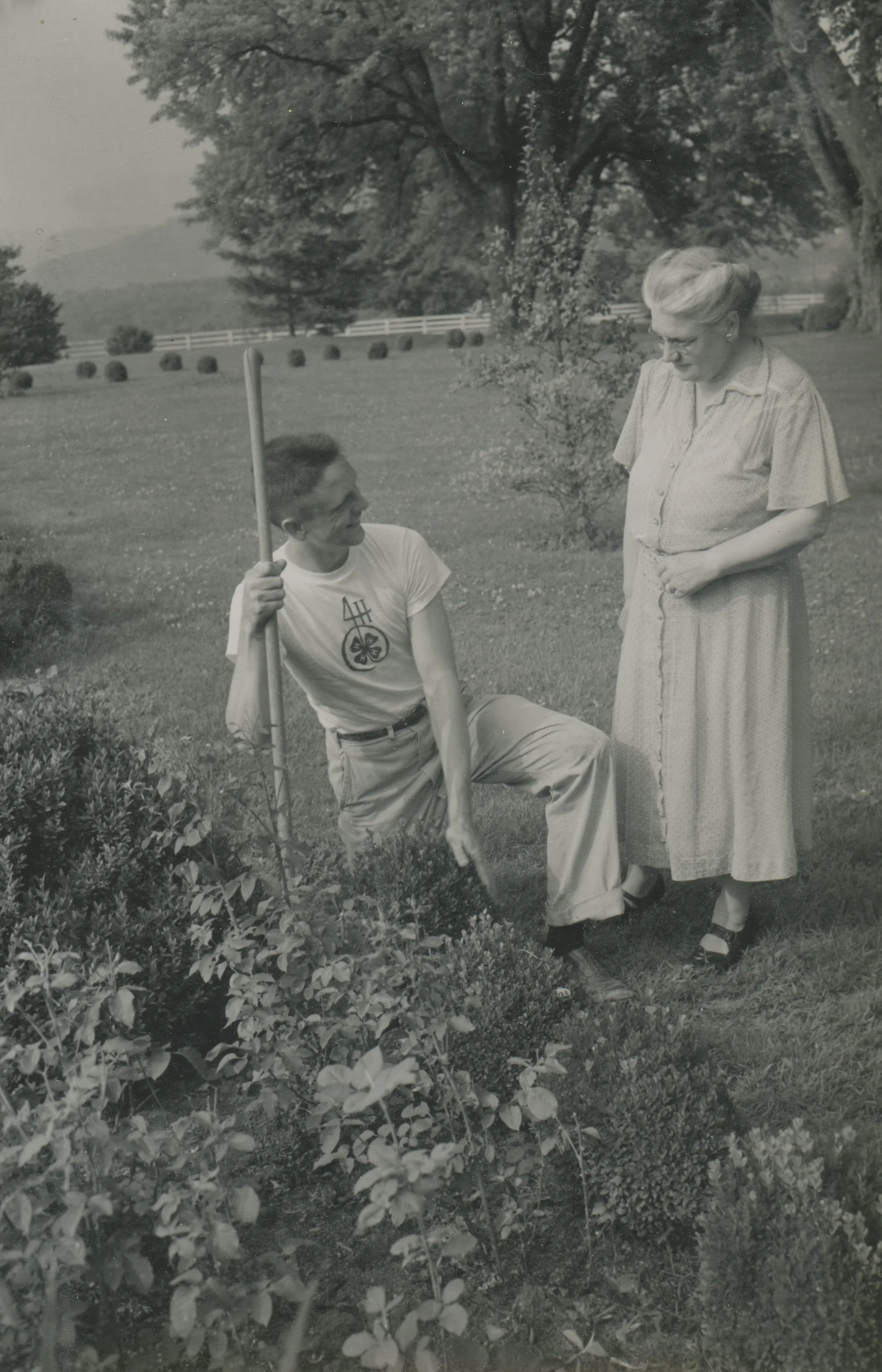 Paul and Mildred looking at some Boxwood in the garden.