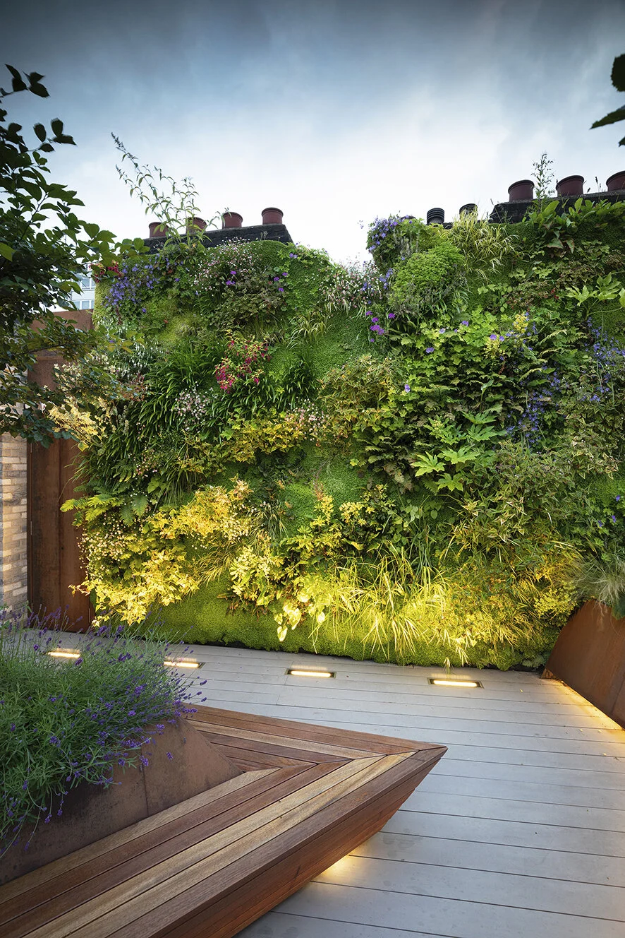 Detailed close-up of vertical garden showcasing a variety of colorful and textured plant species