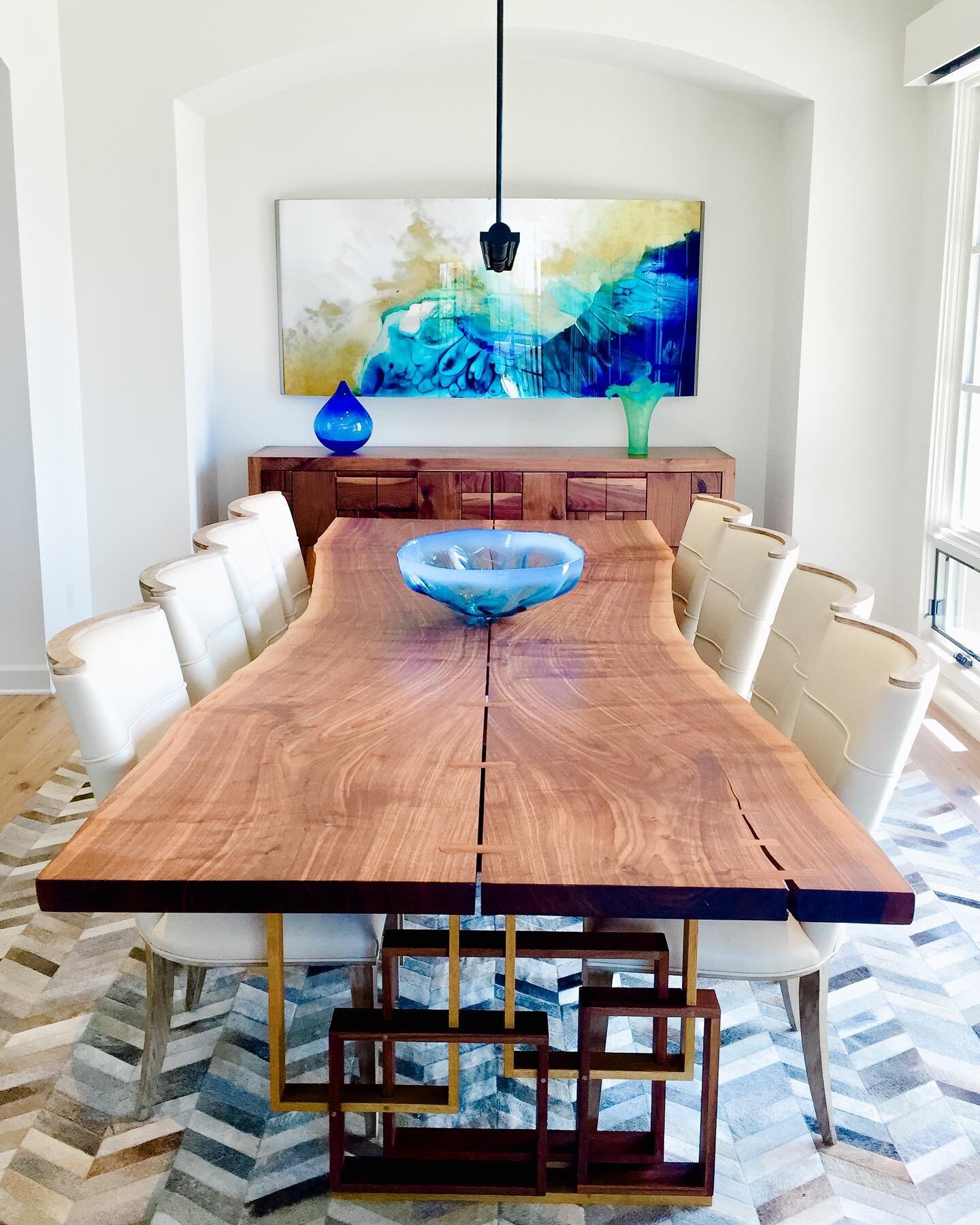 Love this live edge walnut dining table with bronze cast bases.