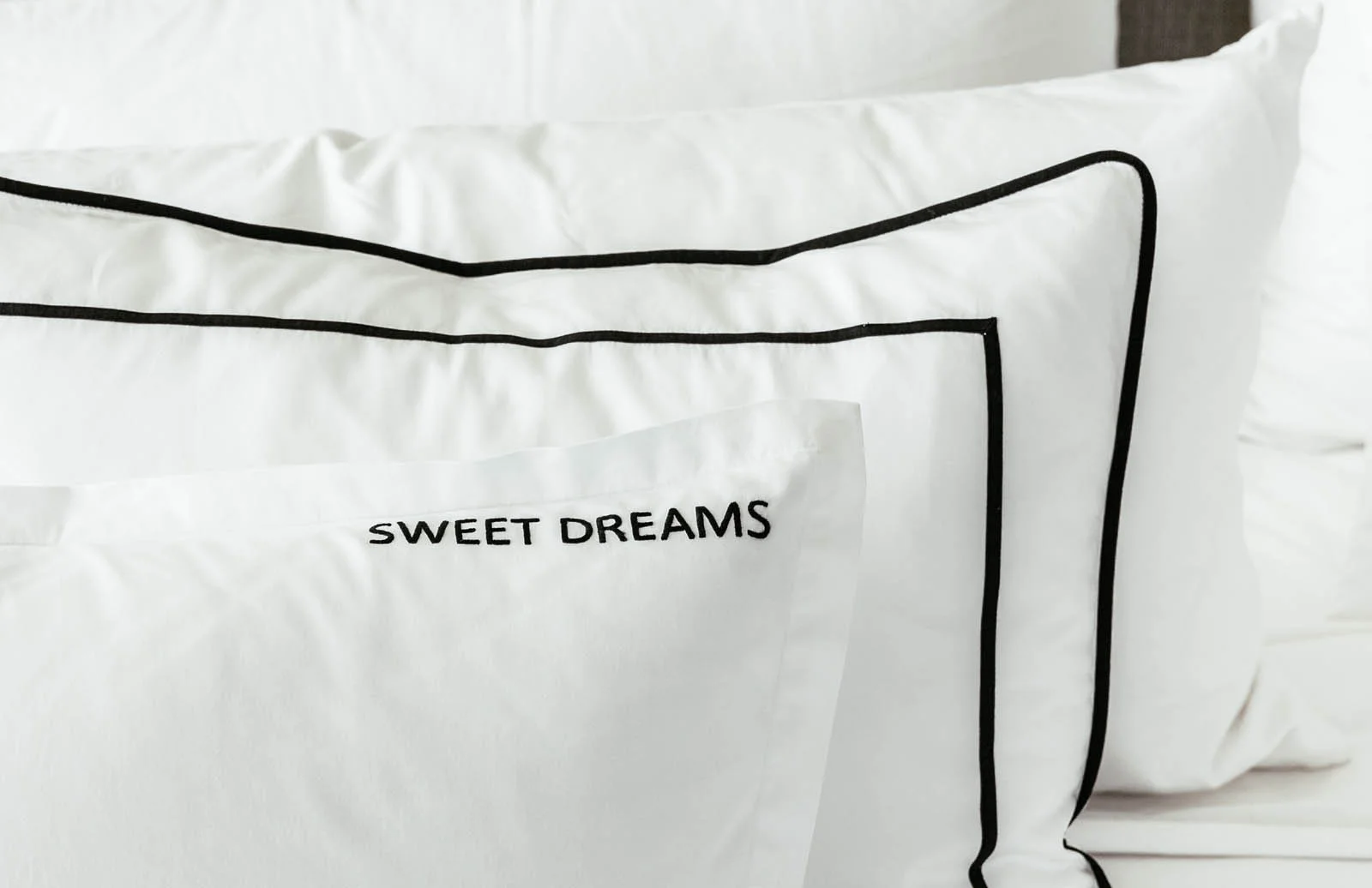 BACK: Sham with binding and 1/4" framed band in black FRONT: Sham with 1" flange and SWEET DREAMS in Jeffrey font. Can be any word you desire,