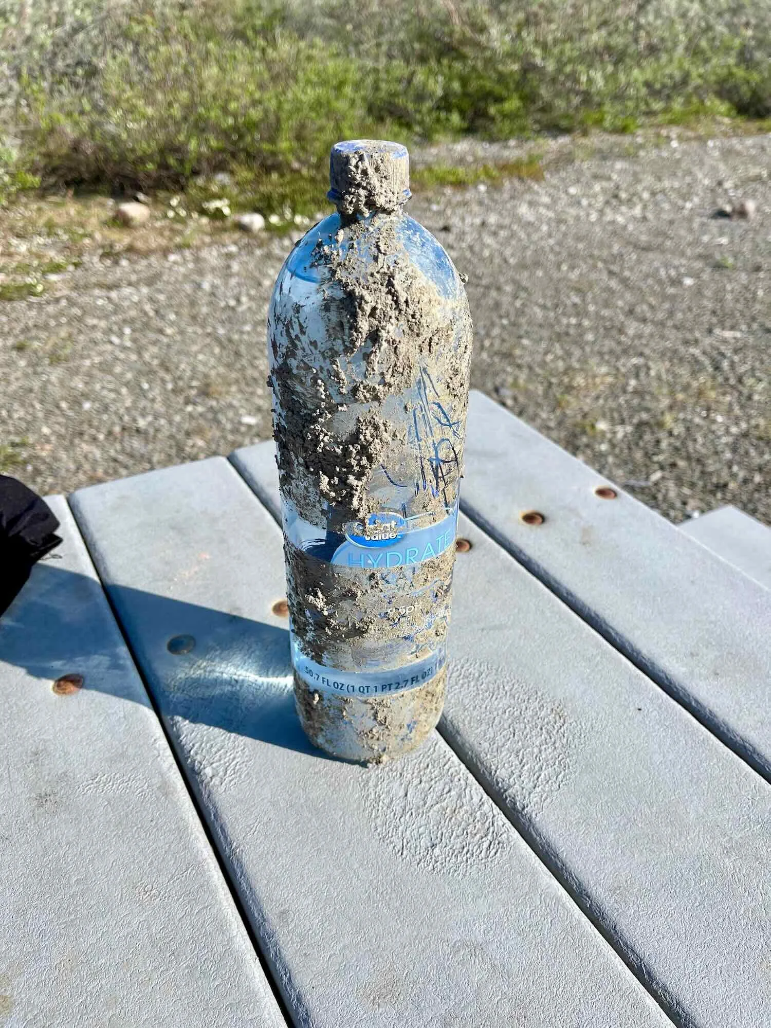 Mud-caked water bottle