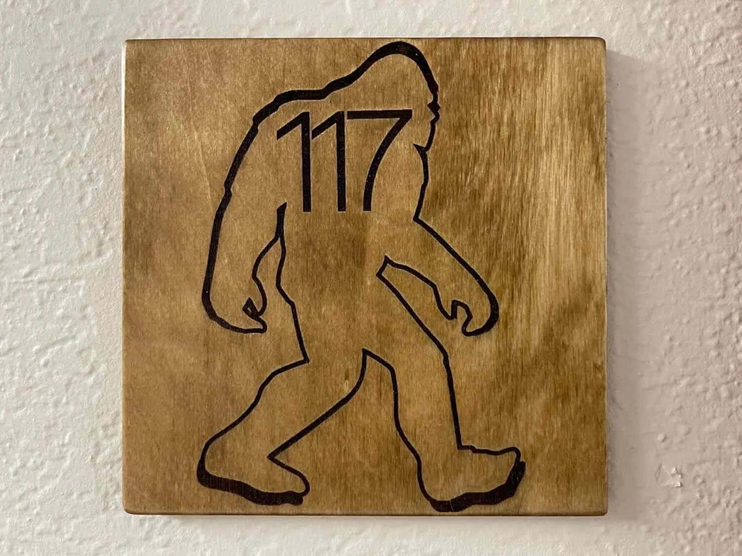 Sasquatch's silhouette frames a room number
