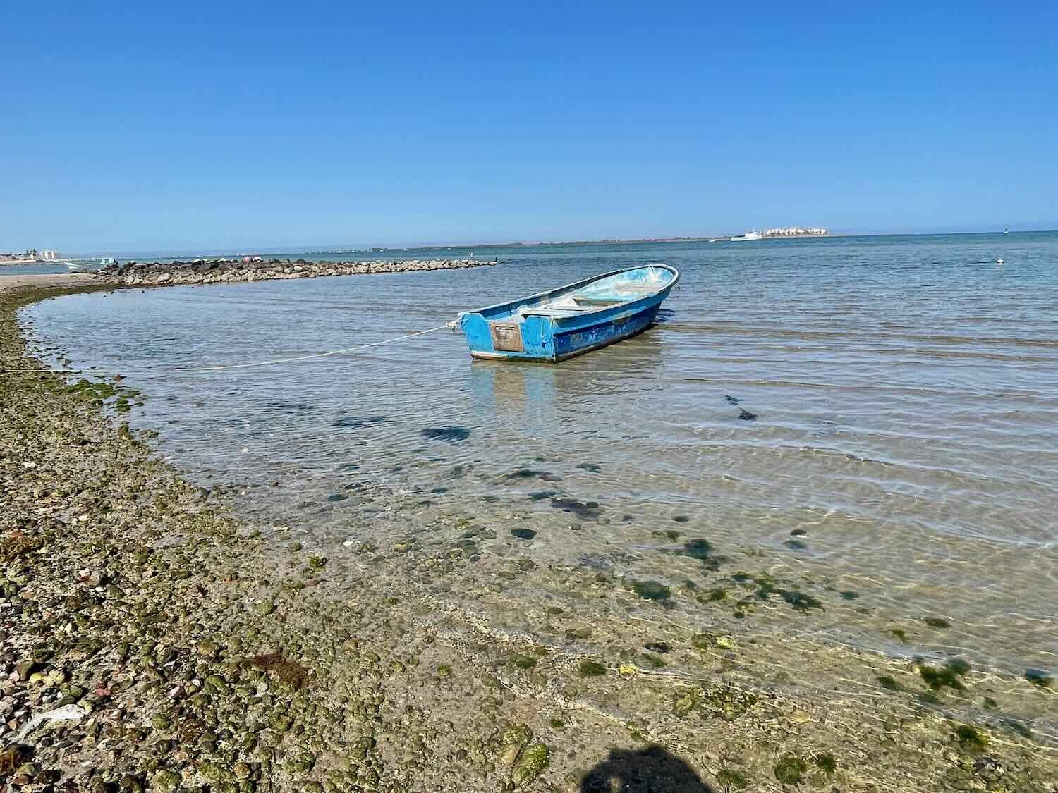 A fishing boat in a small, rocky bay