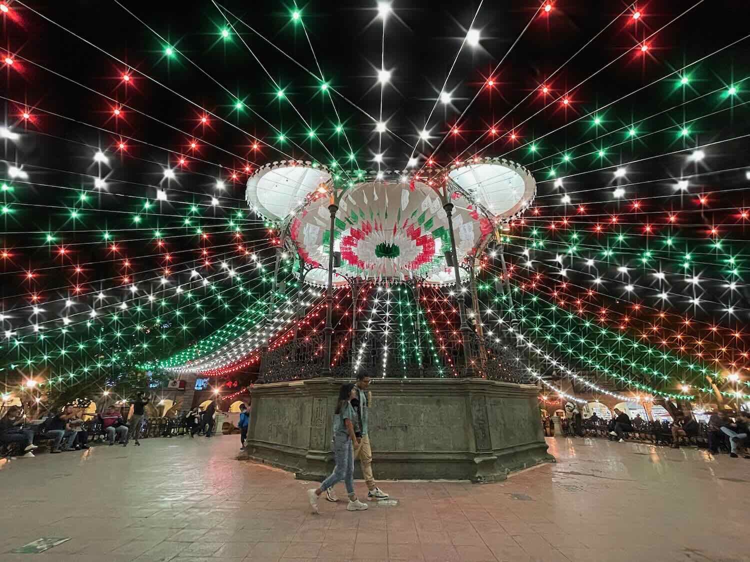 The national colors lit up the central plaza at night