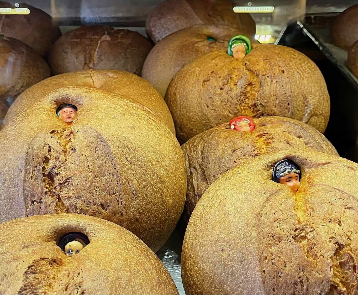 "Pan de Muerto" (bread of death) is a favorite food for the Day of the Dead. Note the "people" buried inside the loaves.