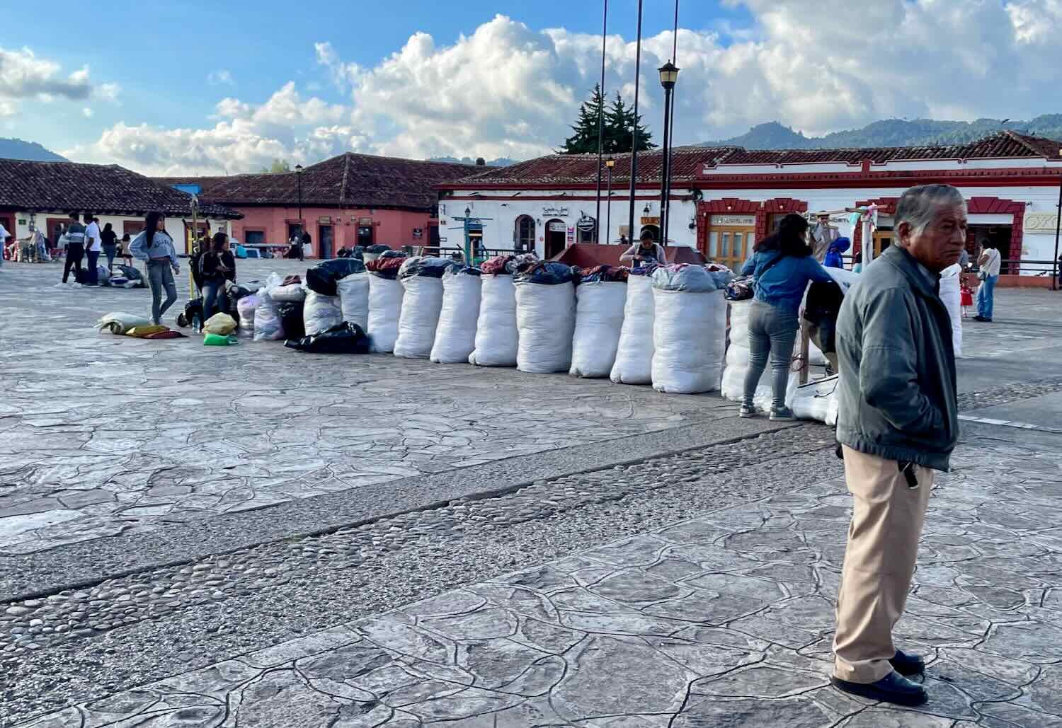 Bags of merchandise lined up, ready to be deployed for the evening market in the plaza