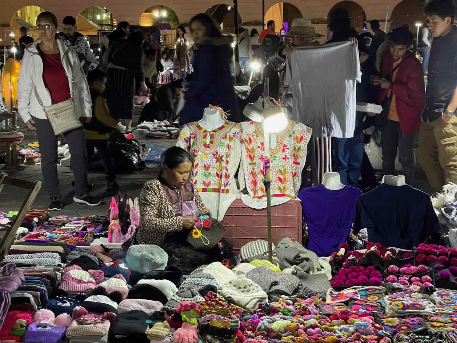 A vendor sews another handmade item