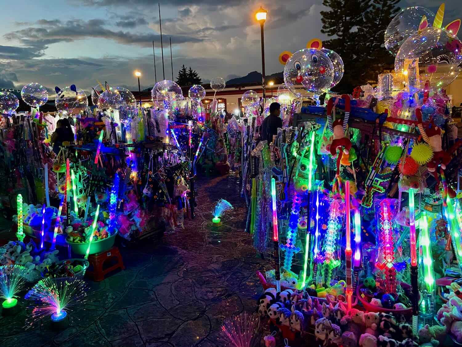 Vendors selling glow-sticks and sparkling toys clustered together on one side