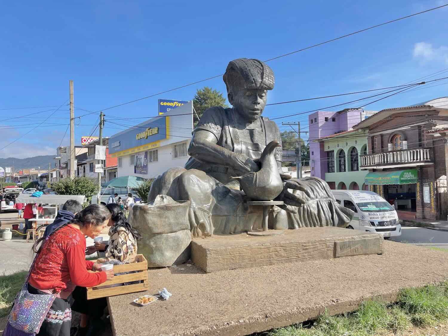 Statue of "La Artesana," an indigenous artist creating a clay dove