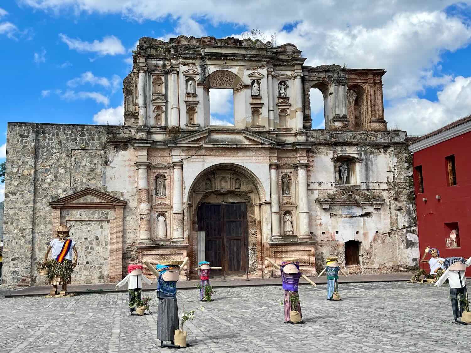 Ruins of a historic Catholic school, with statues in the courtyard