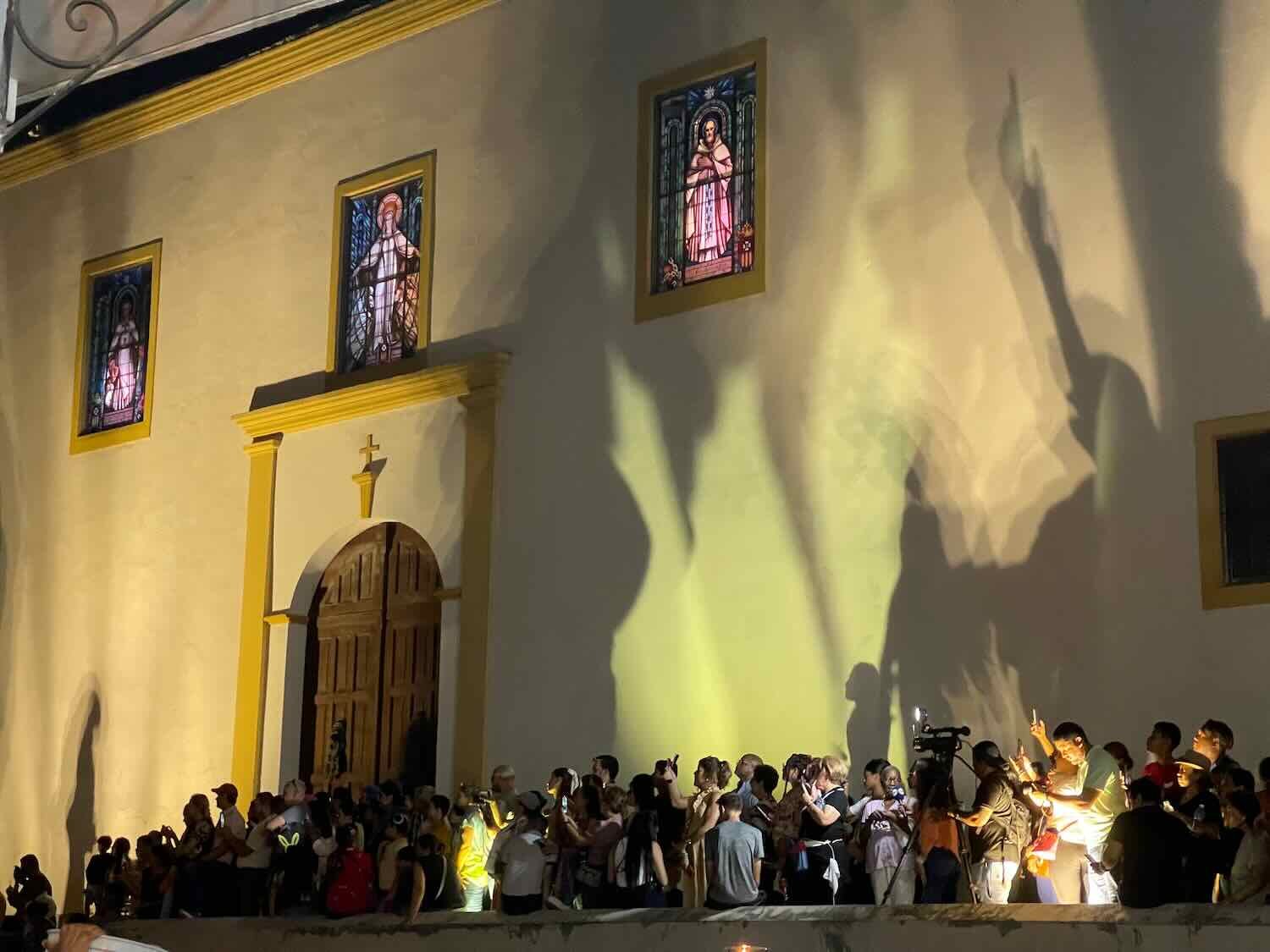 Shadows from the procession danced on the wall of the Church of Mercy, near the start of the procession