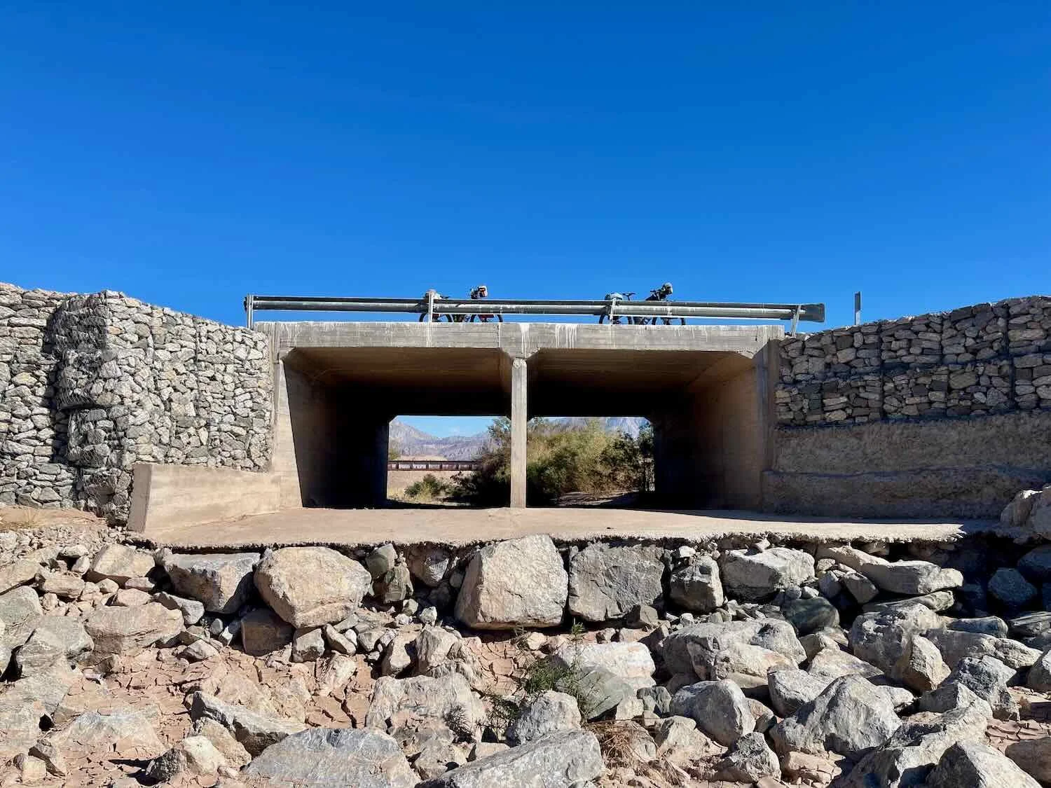 Our bikes stayed on this bridge, while we went down into the dry arroyo to sit on the rocks for a rest break