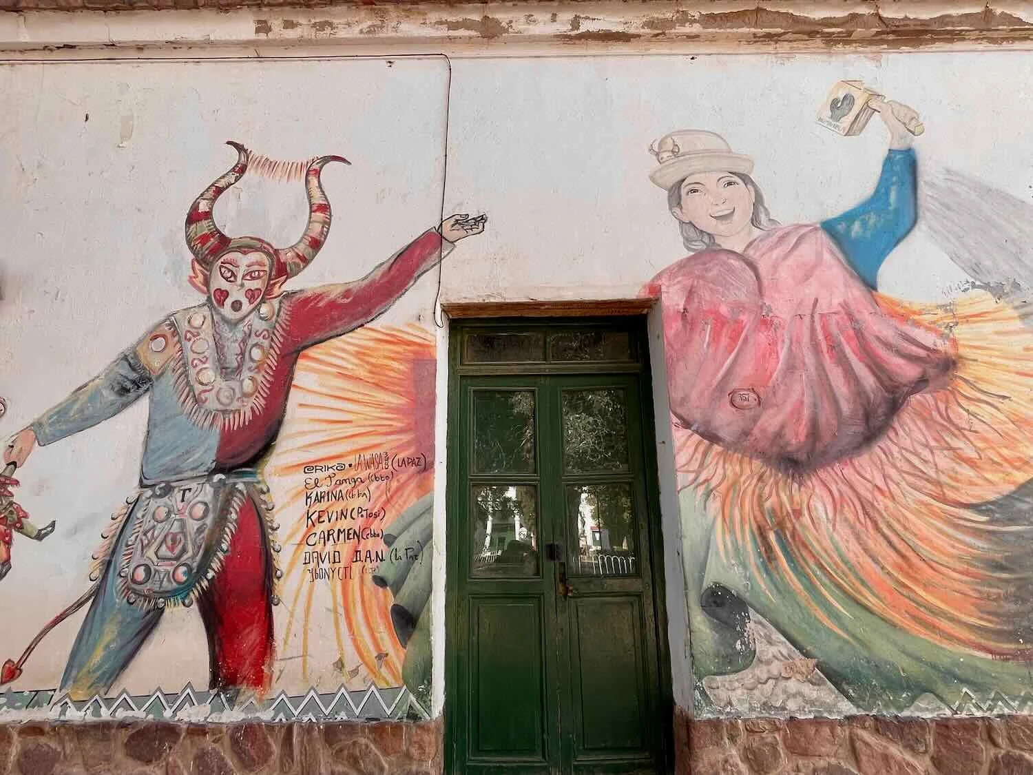 Mural of dancers in a Diablada parade, representing the struggle between good and evil