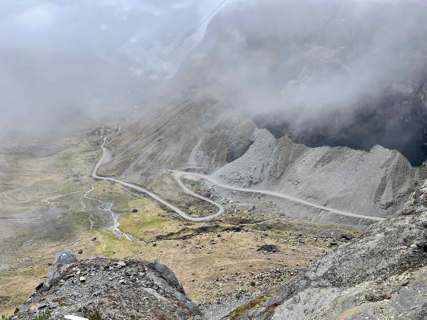 Looking down into the valley where we would be cycling. We began the tour well above the vegetation line. Intermittent, thick clouds hugged the mountains all around us.