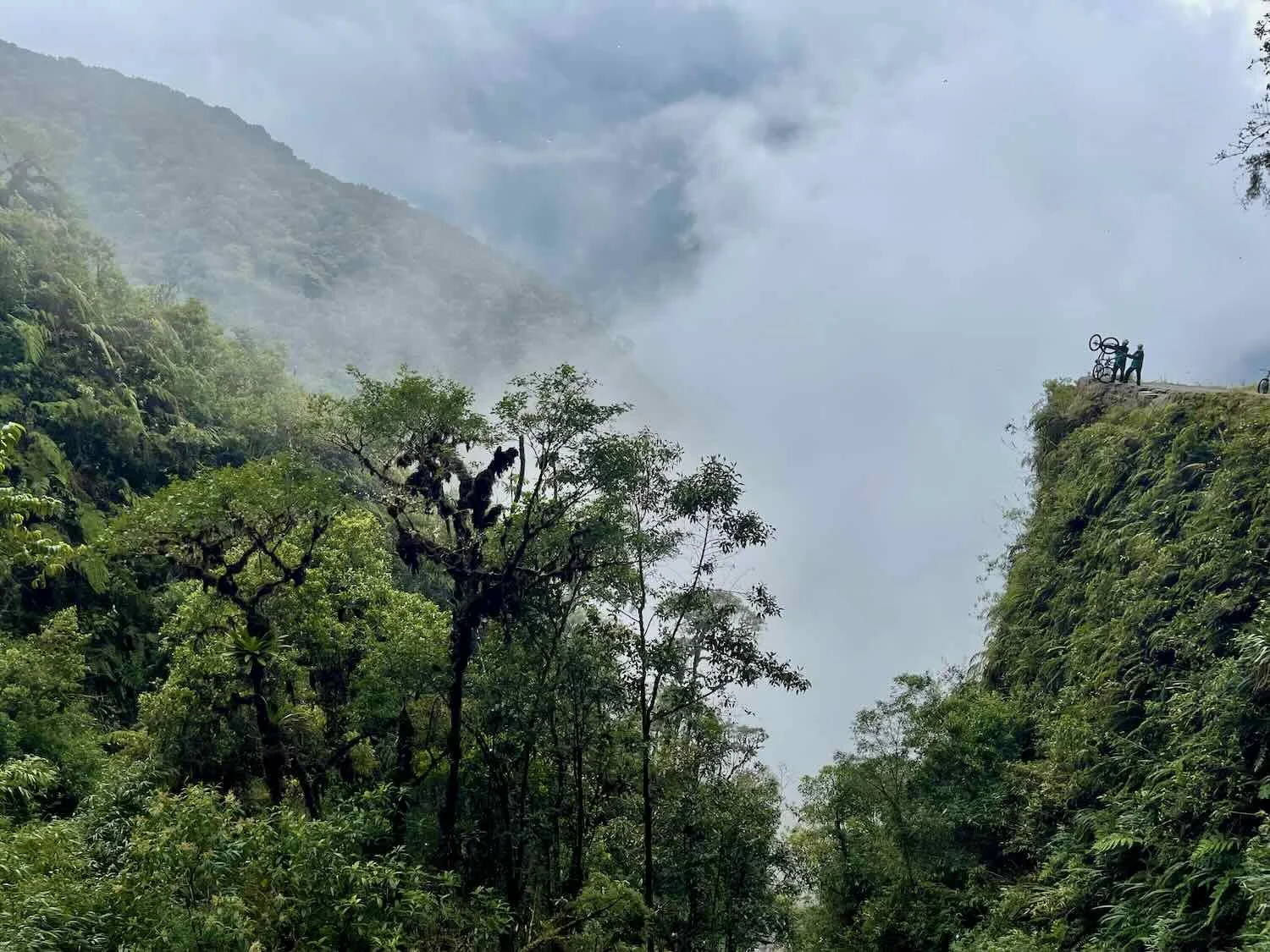 That's us - raising our bikes in salute as the valley falls away for thousands of feet below us.