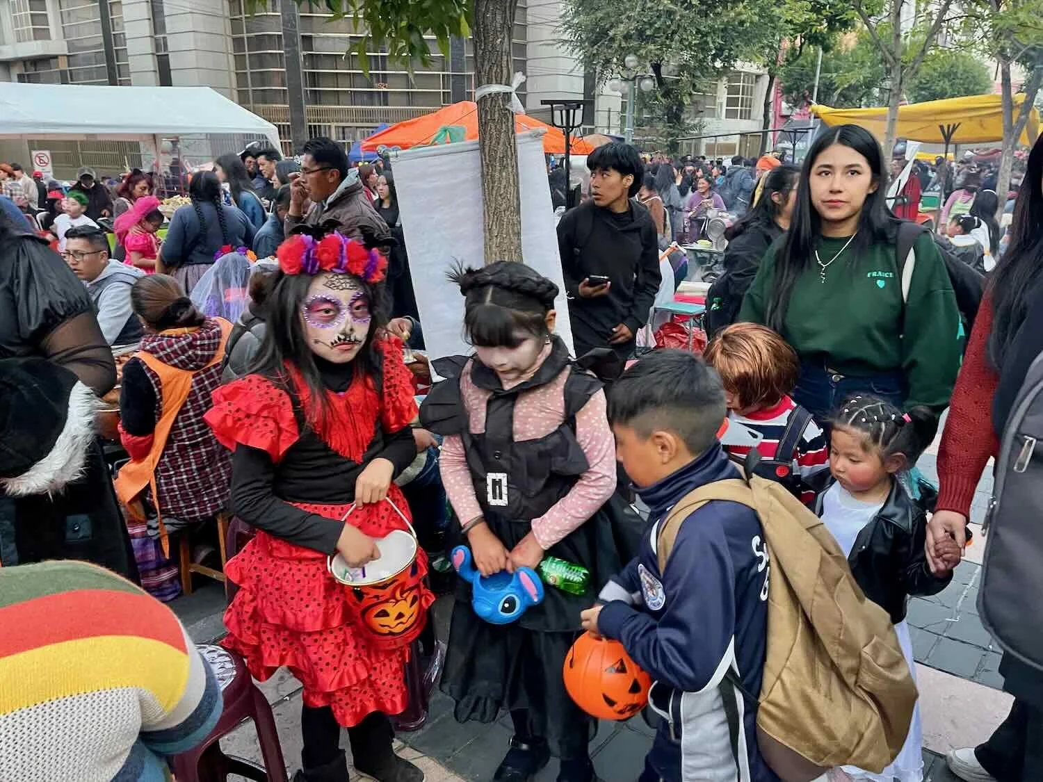 Kids filled their buckets with Halloween treats collected from other kids' parents.