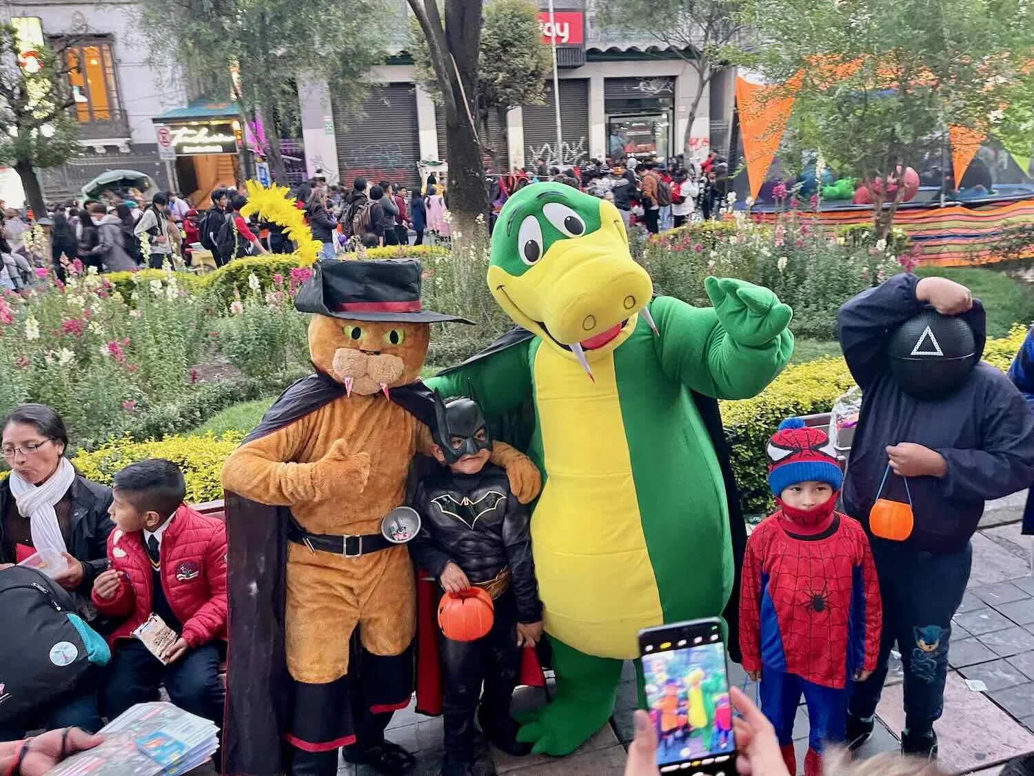 Characters in costumes posed for Halloween photos with the kids.