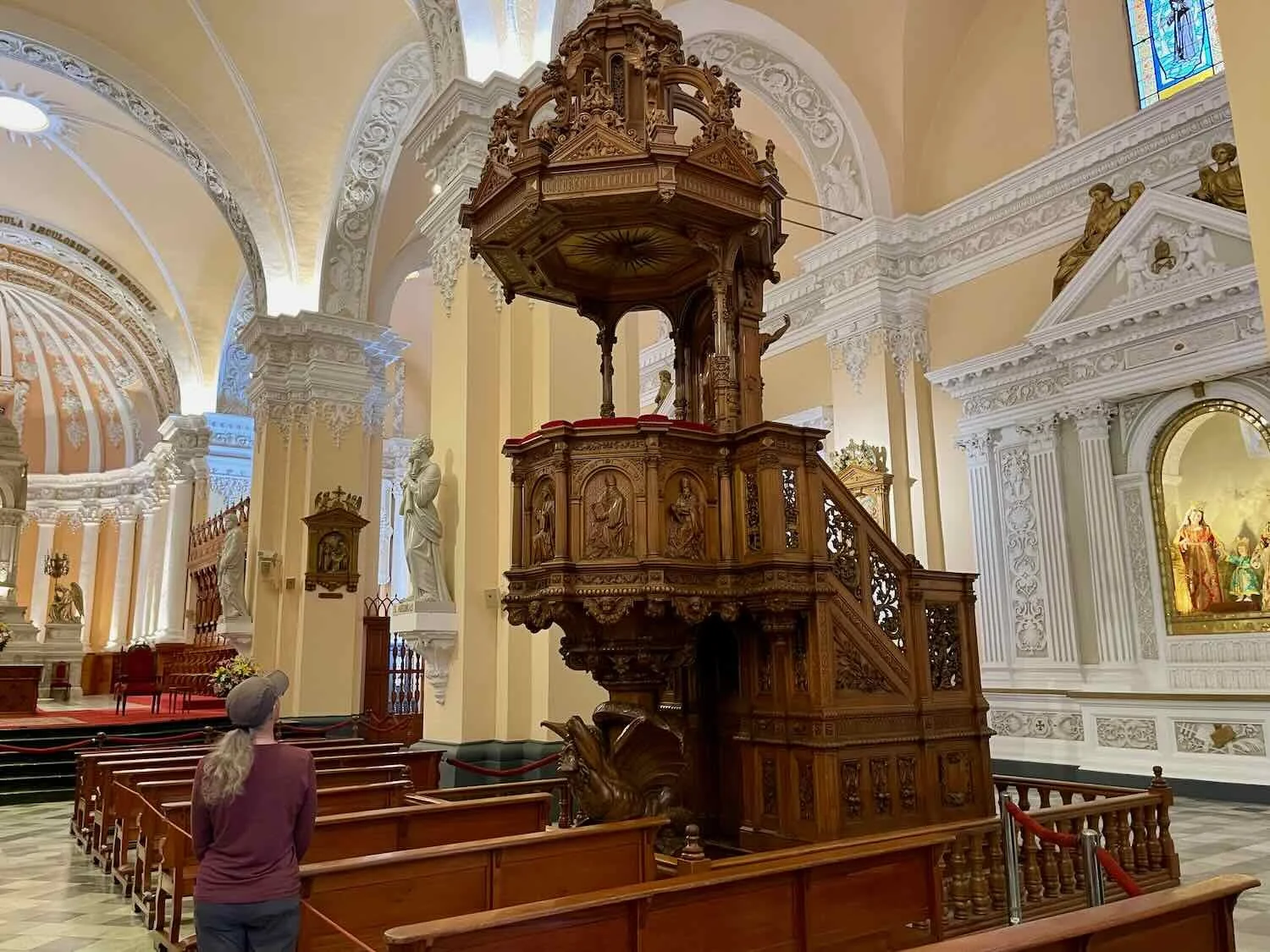 The carved wooden pulpit imported from France sits atop a winged devil figure.