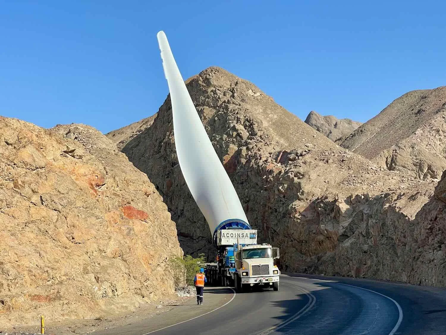 The truck was moving so slowly that the guy in front was able to run backward, making sure the blade would clear the mountains.
