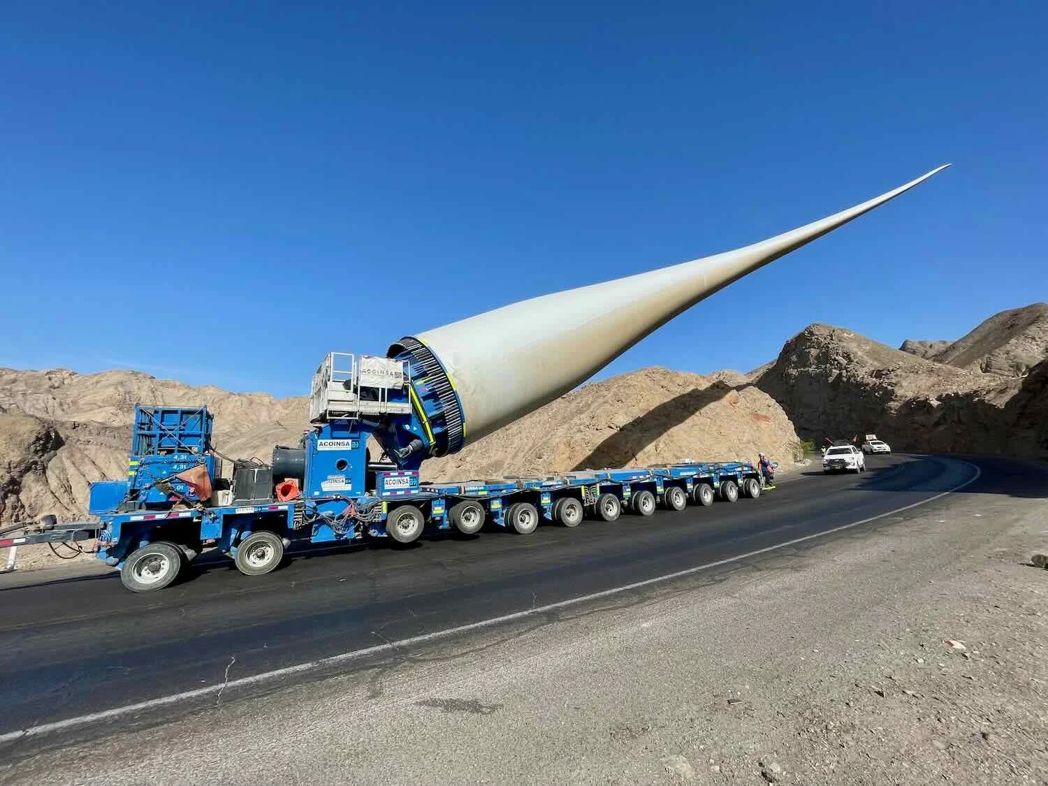 It was amazing to watch the truck maneuver down the hill, with a 75 yard (70 m) wind turbine blade perched on one end. Look at all the wheels on that truck.