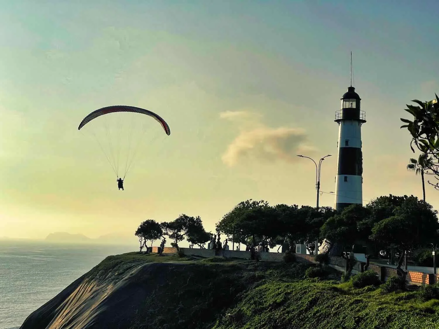 Paragliding past La Marina Lighthouse