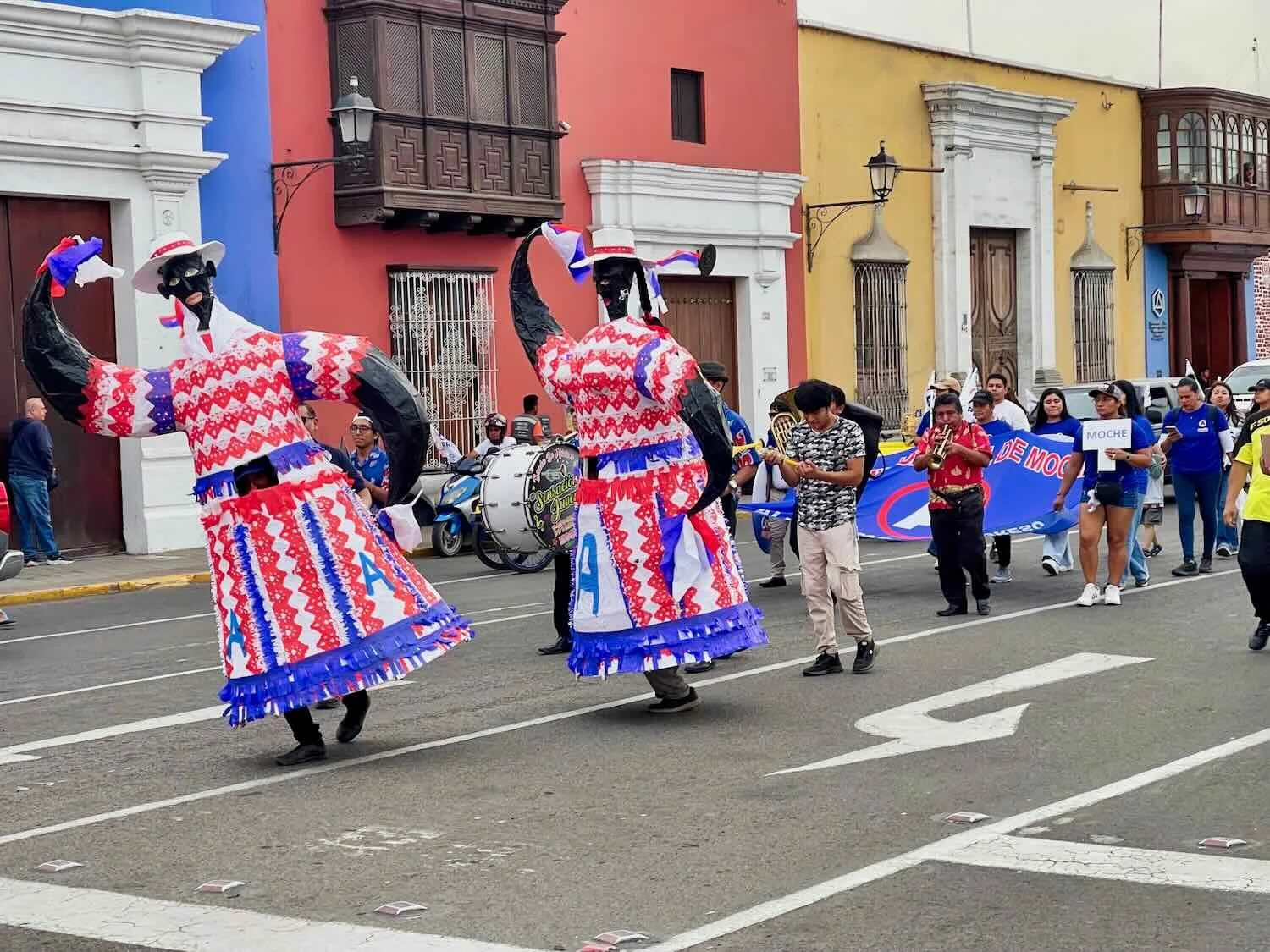 Characters in a political parade at the Plaza de Armas