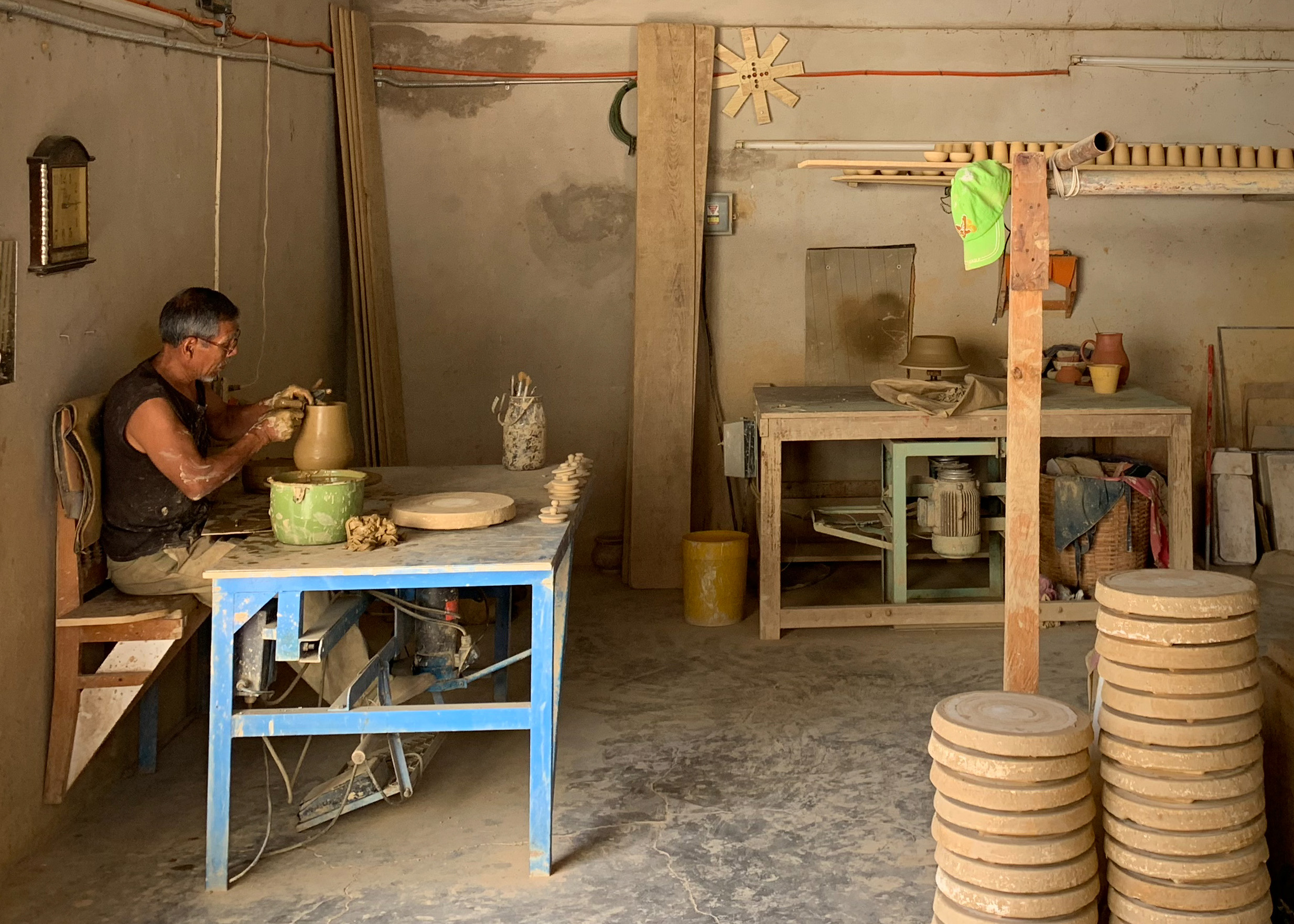 An artisan shaping a clay pitcher.