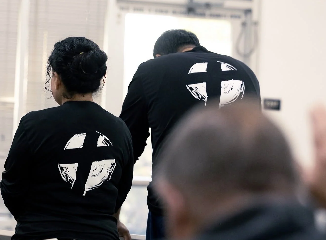 A couple standing in a saved and sober recovery group.