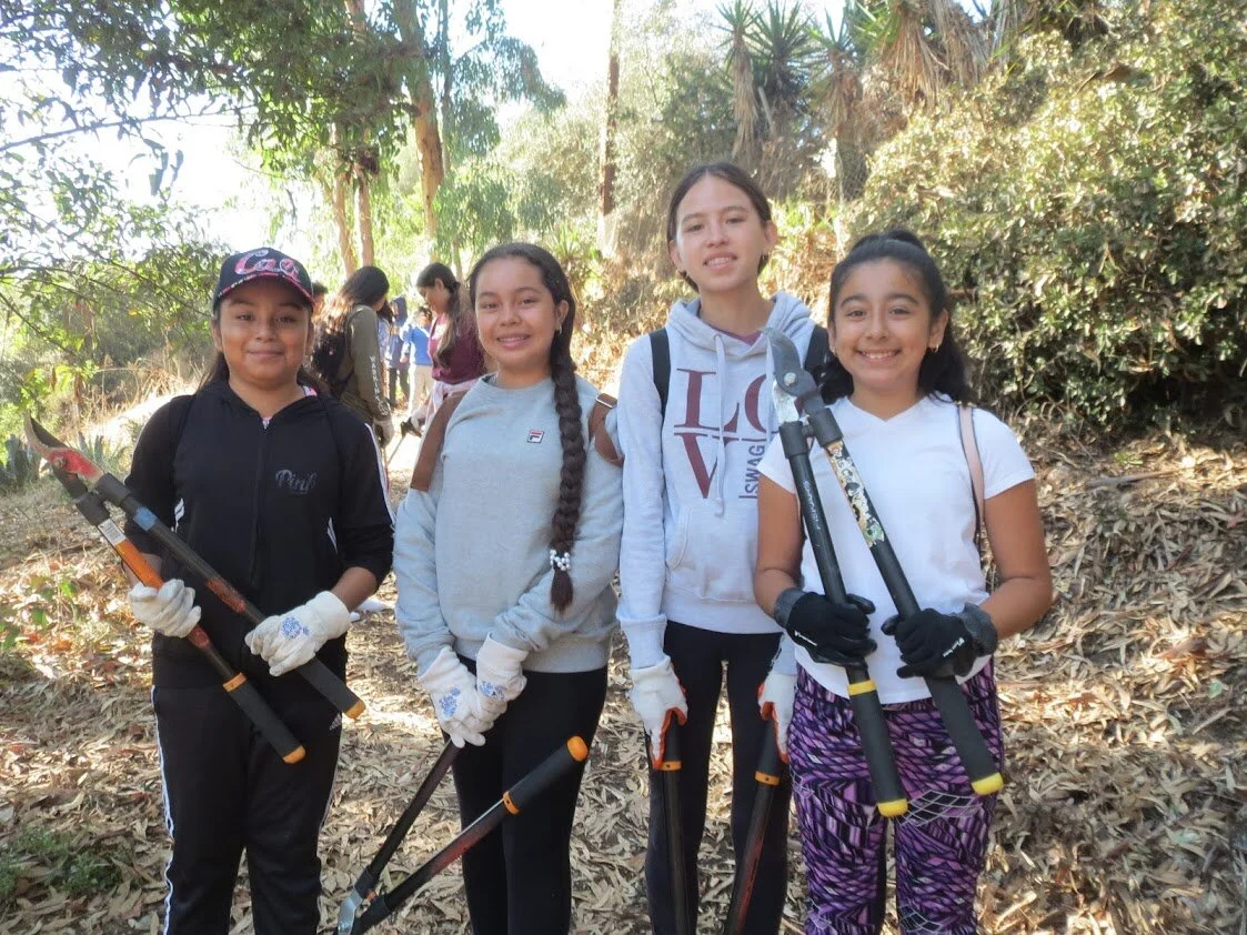 youth volunteers with loppers