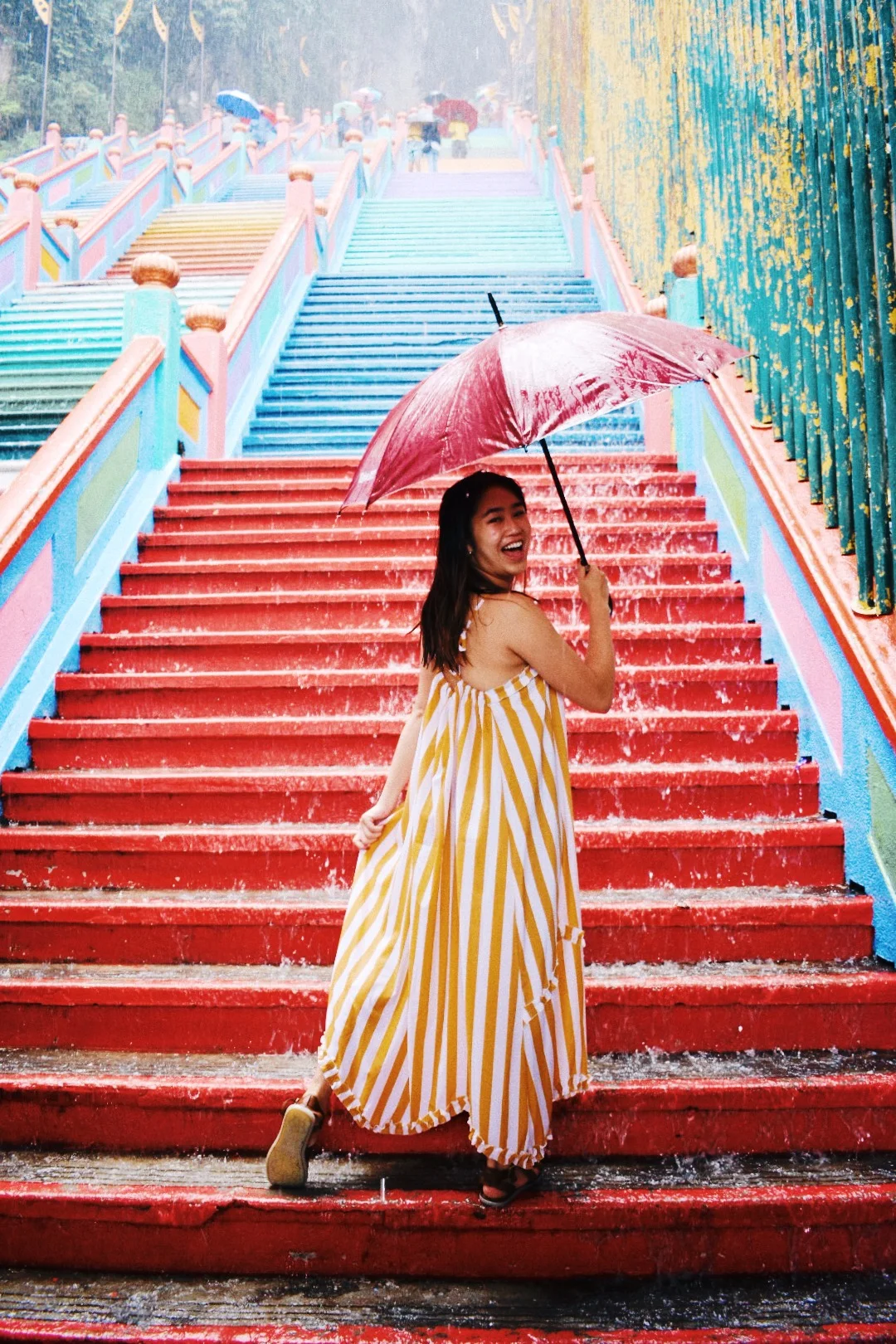  After we reached the top of the stairs, it started pouring! I ended up walking down in the downpour without an umbrella. As I waited at the bottom for the others, I borrowed an umbrella to take some pics 