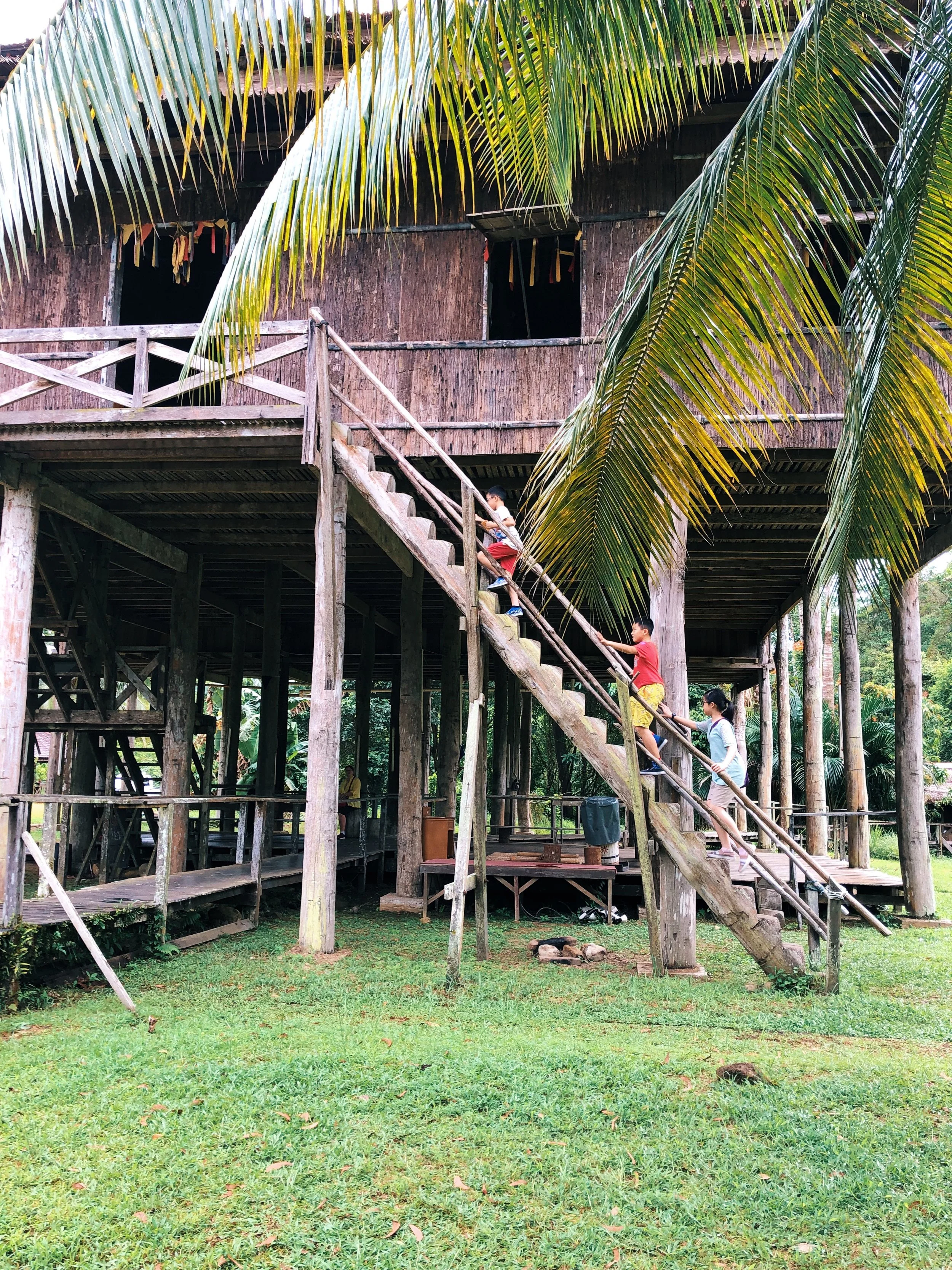 My little cousins climbing the log stairs at the cultural village