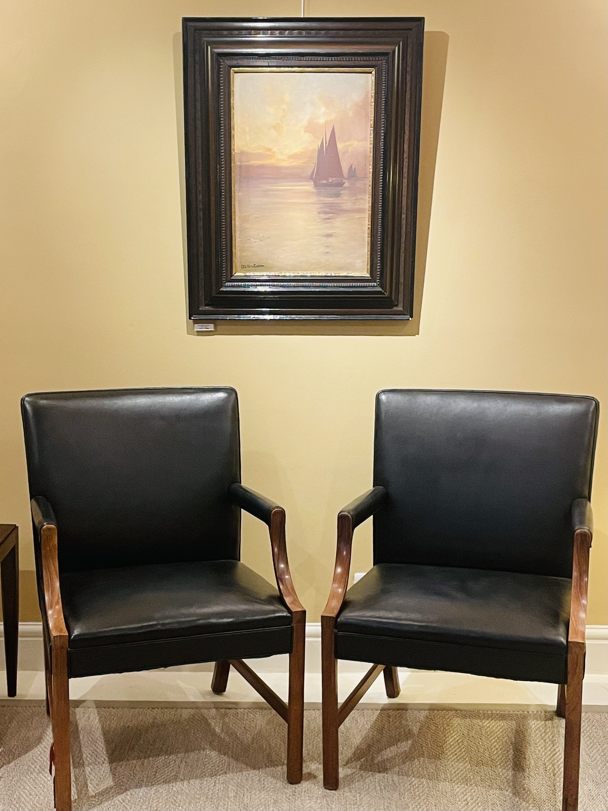 A Pair of Ole Wanschner 50's Armchairs.  Upholstered in black leather with Rosewood Frame.
