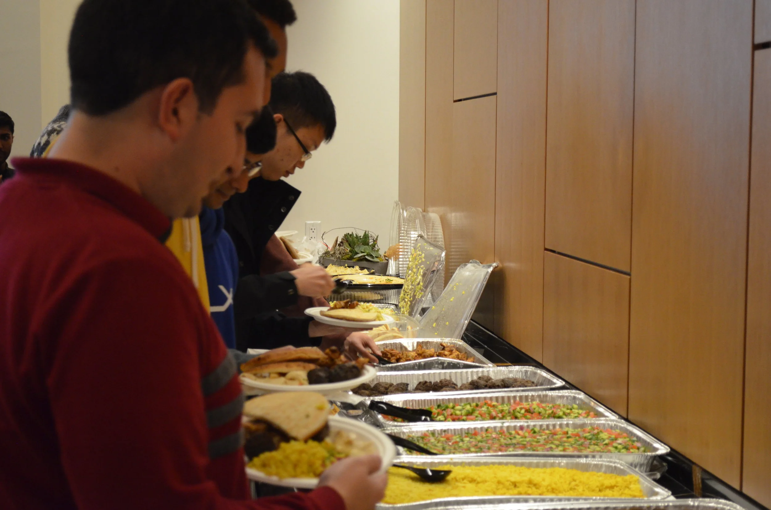 Attendees grabbing food from Oren’s Hummus