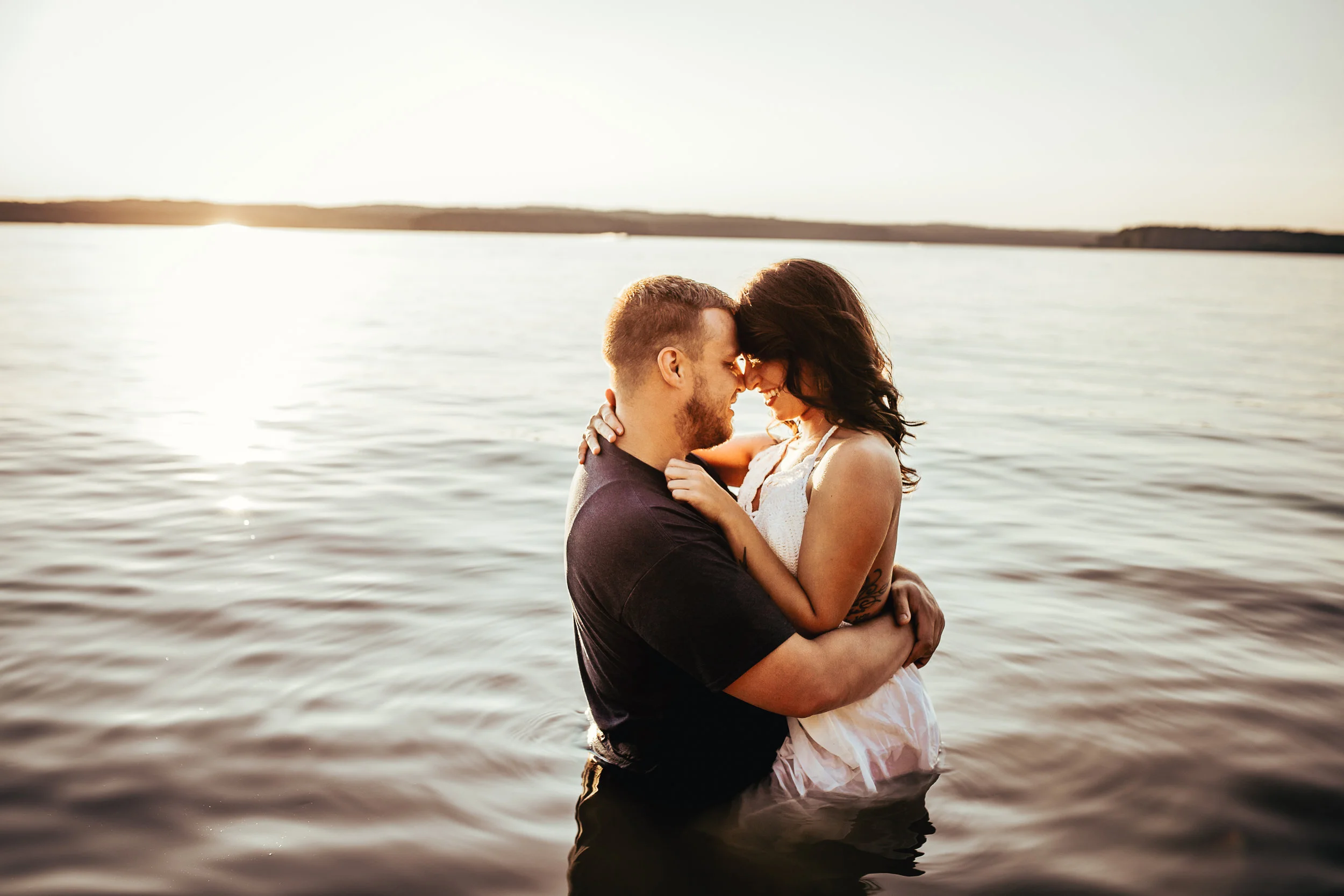 It was in the middle of summer and I had been wanting to do a session in the water, so I found the perfect spot on a lake and in the water I went with my clients to get these steamy shots! It was so much fun! & the cool water was definitely nice on that hot day!