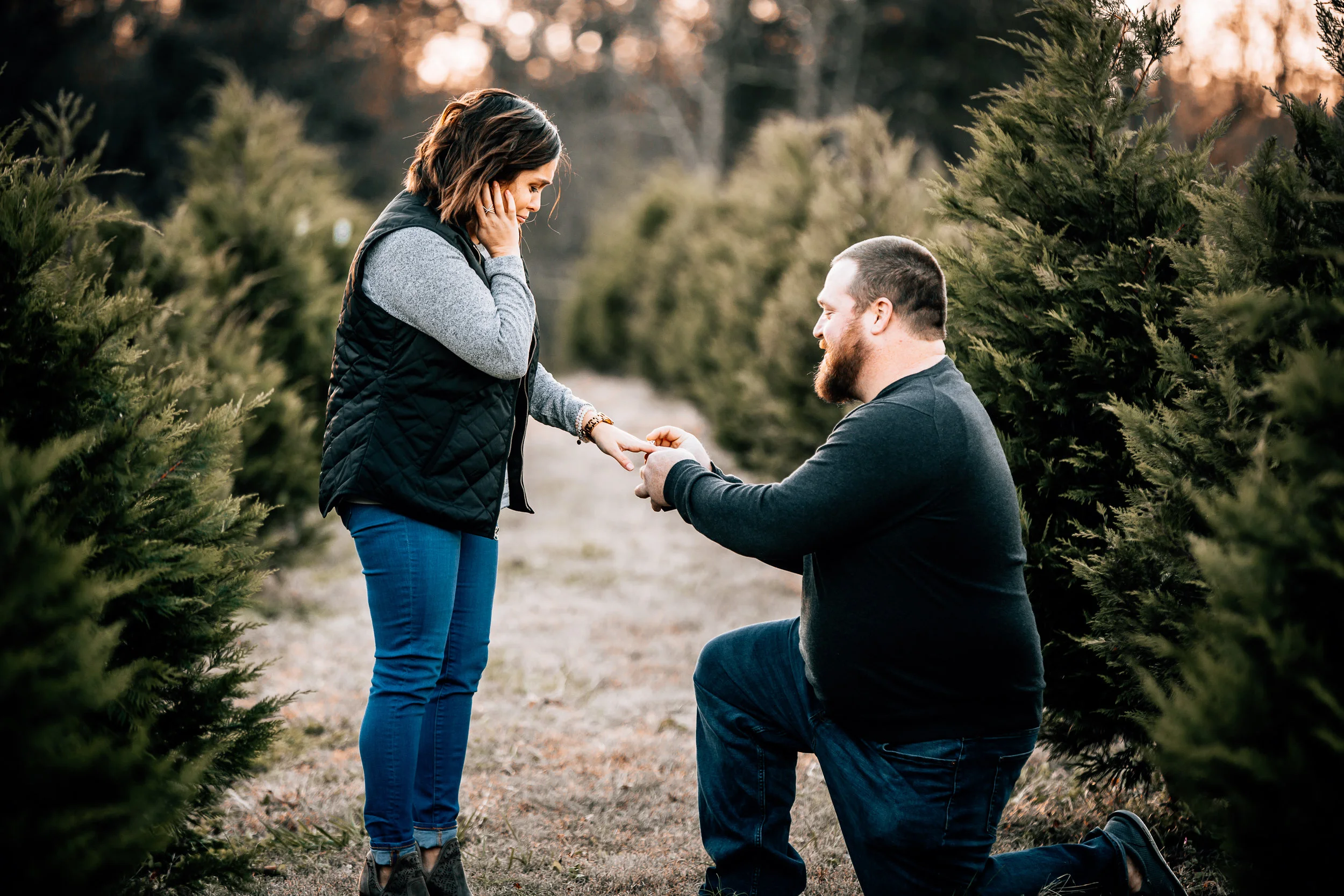 This is kind of a funny story (You are probably wondering how a proposal is funny, and it’s not what you think!) but Katie had booked one of my Christmas Card Sessions for her & Kevin back in November. They brought their two fur babies and Katie’s dad & sister to help with their doggies while they had their photos taken. I told Katie & Kevin to walk away from me when we first started to get them in position where I wanted them at & Katie’s dad had whispered in my ear “Whatever you do, DON’T stop taking pictures!” & normally I am like… super slow to catch onto things, but something just clicked in my brain with the way he said that and I whispered back “Is he going to propose to her?!” & he said “Yes!” so I told them to face each other and I kind of paused for a minute because I was not sure if Kevin wanted to go ahead and ask or not. But luckily as I paused he took the opportunity and got down on one knee and it was SO SWEET, y’all. Katie seemed SO surprised and it was just the most precious moment to witness. & now I get to capture their wedding day in September & I cannot wait for more sweetness from these two!