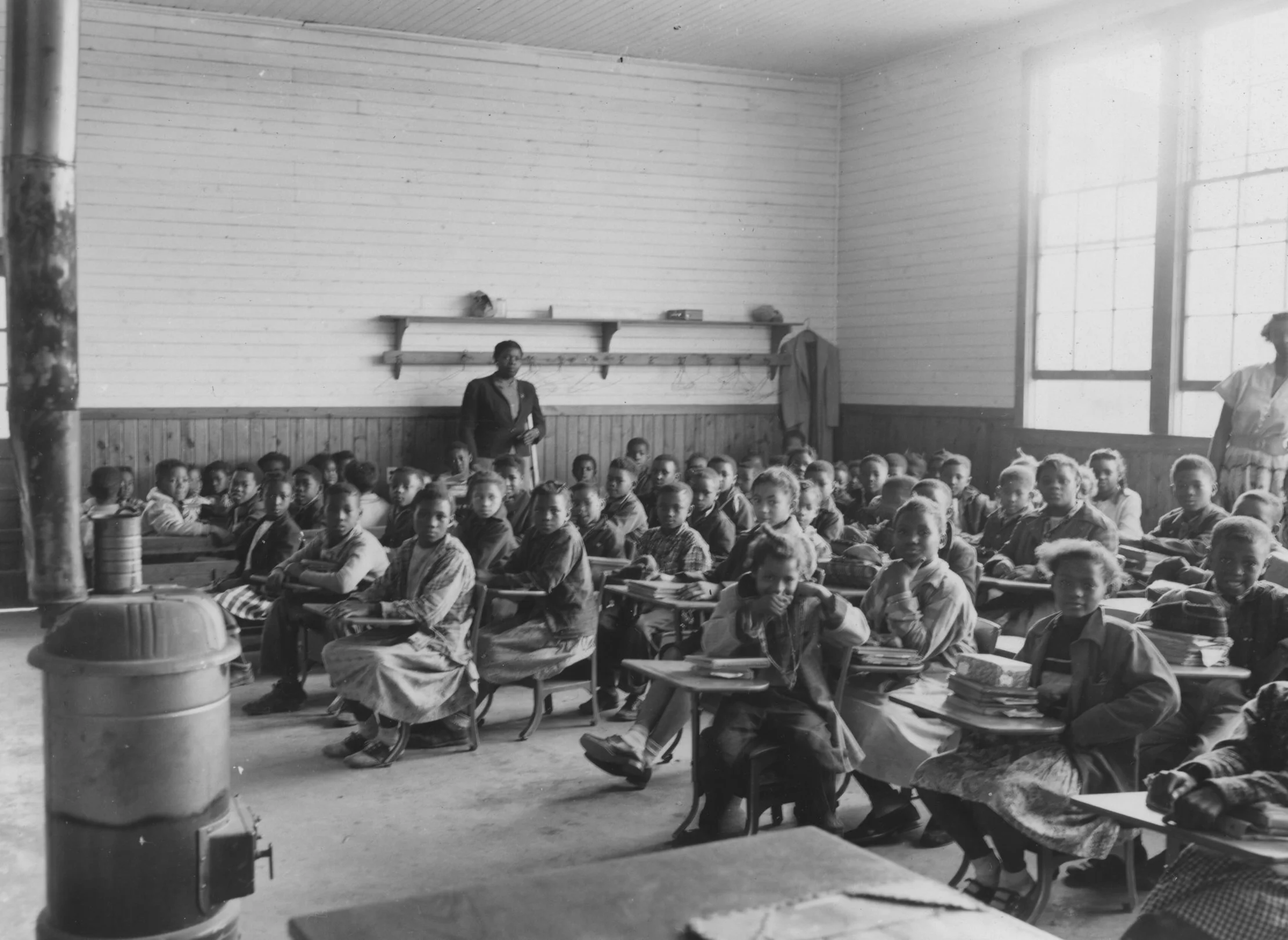 The only heat for students in the Sherman Creek Elementary School in Tallahatchie County in 1955 was the wood heater in the middle of the room. John E. Phay collection at the University of Mississippi Libraries Digital Collections