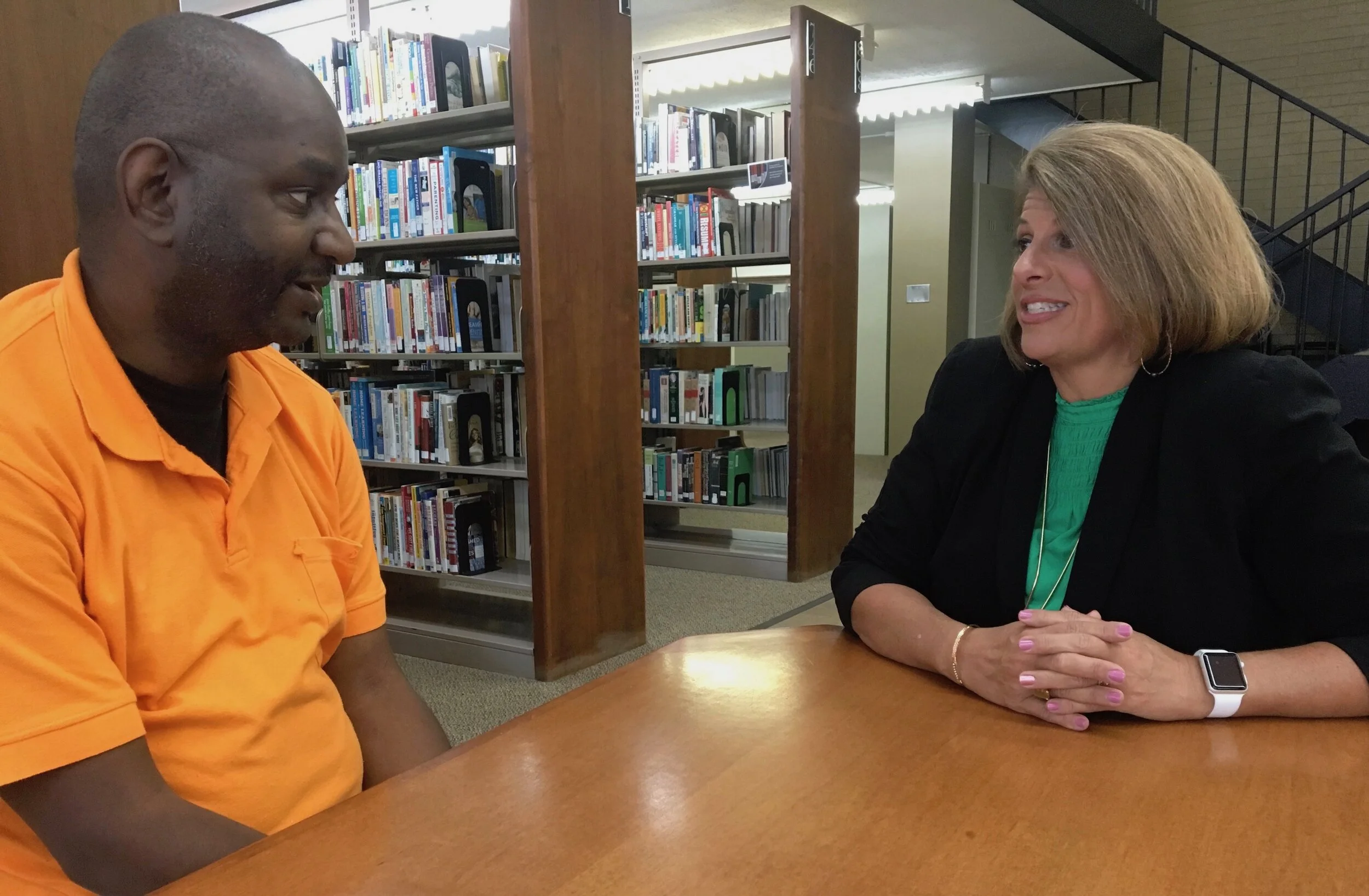 Bobby Thomas talks with his mentor, Angela Ladner, executive director of the Mississippi Psychiatric Association. Billy Watkins/Mississippi Center for Investigative Reporting
